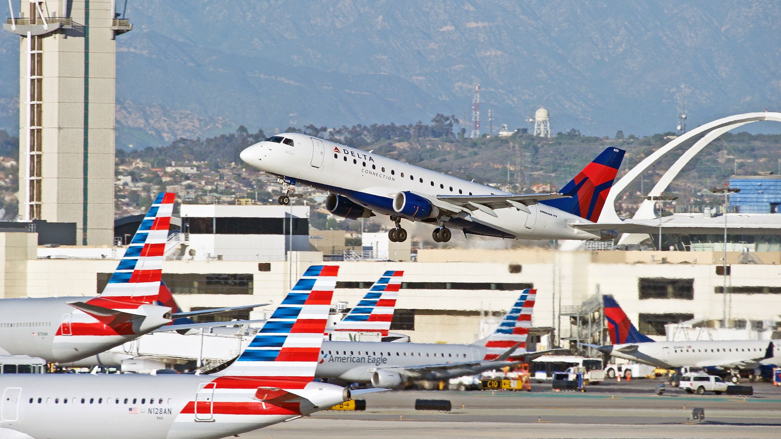 American Airlines and Delta Air Lines aircraft at Los Angeles International Airport LAX shutterstock_589877828
