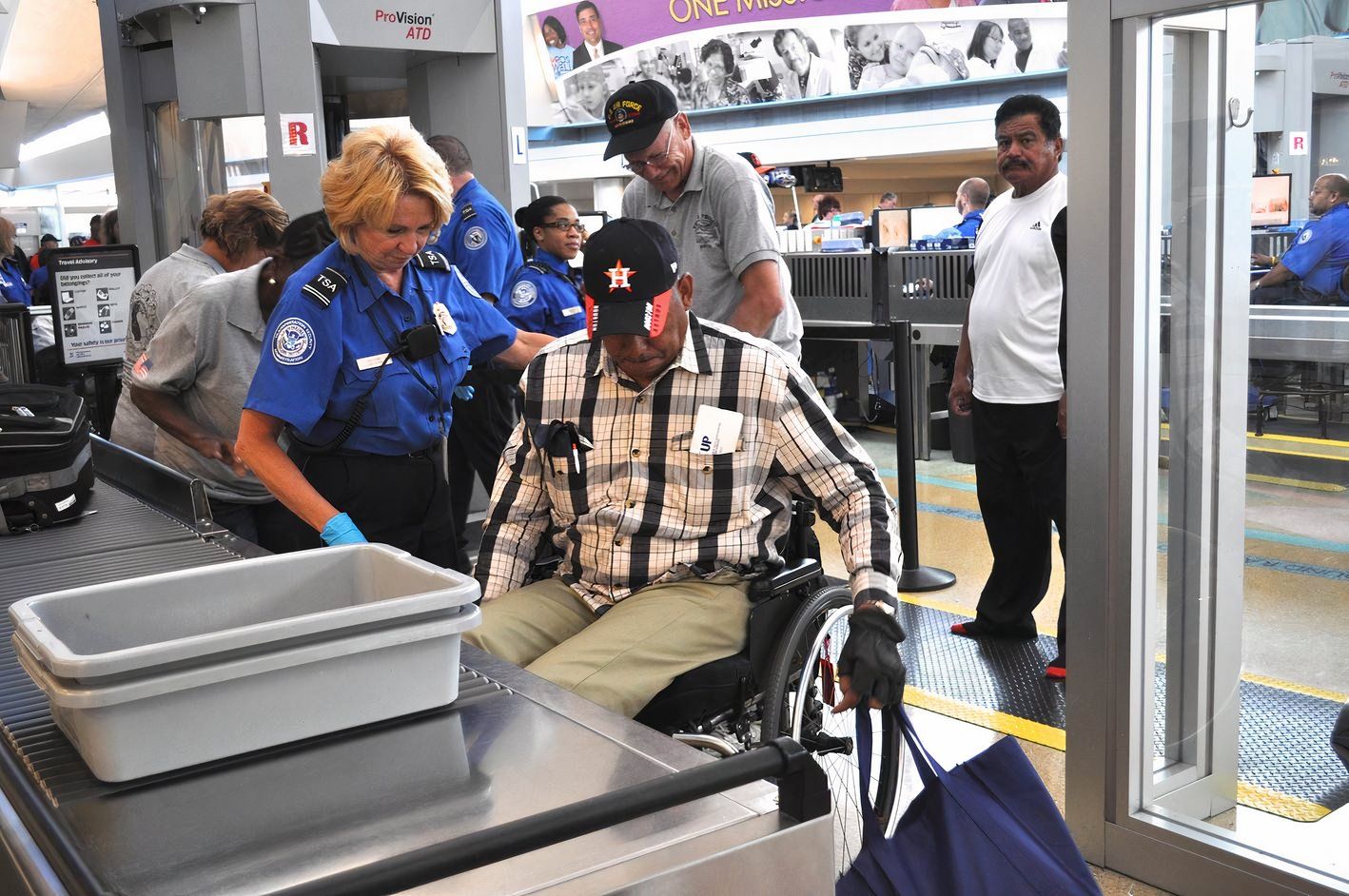 TSA officer and man in a wheelchir