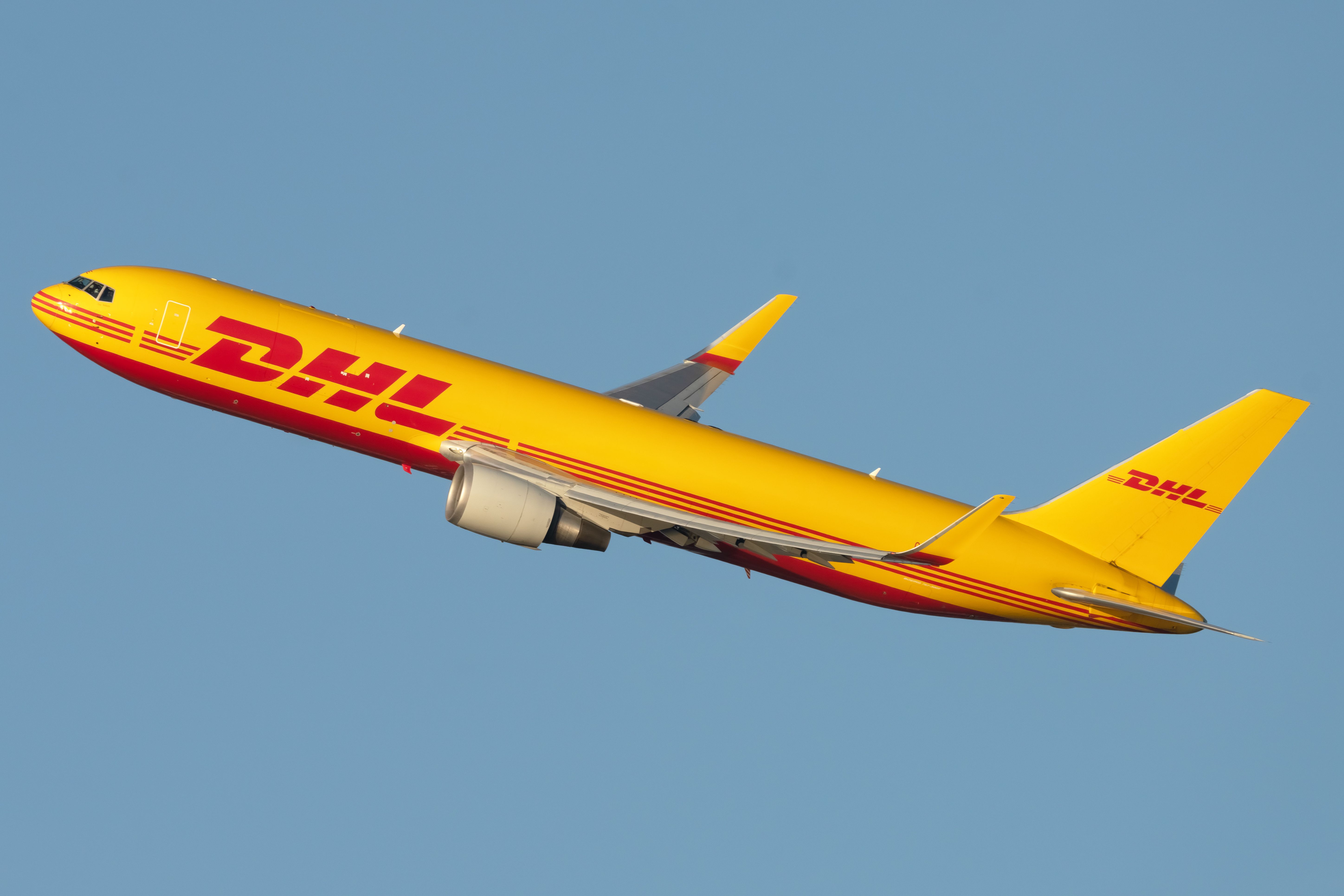 A DHL Boeing 767F aircraft taking off from JFK Airport.