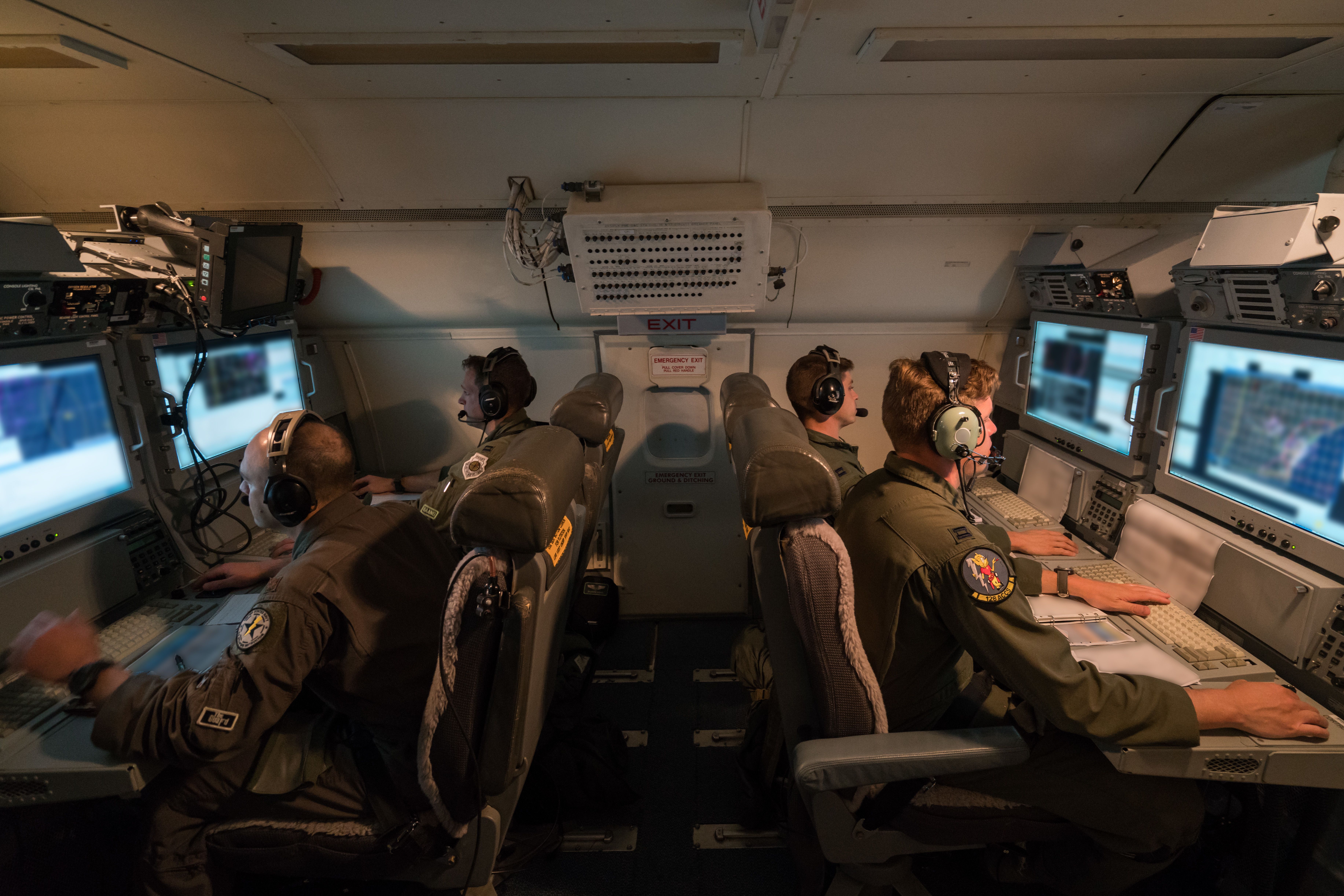 Photo of E-8C Aircrew analyzing radar data