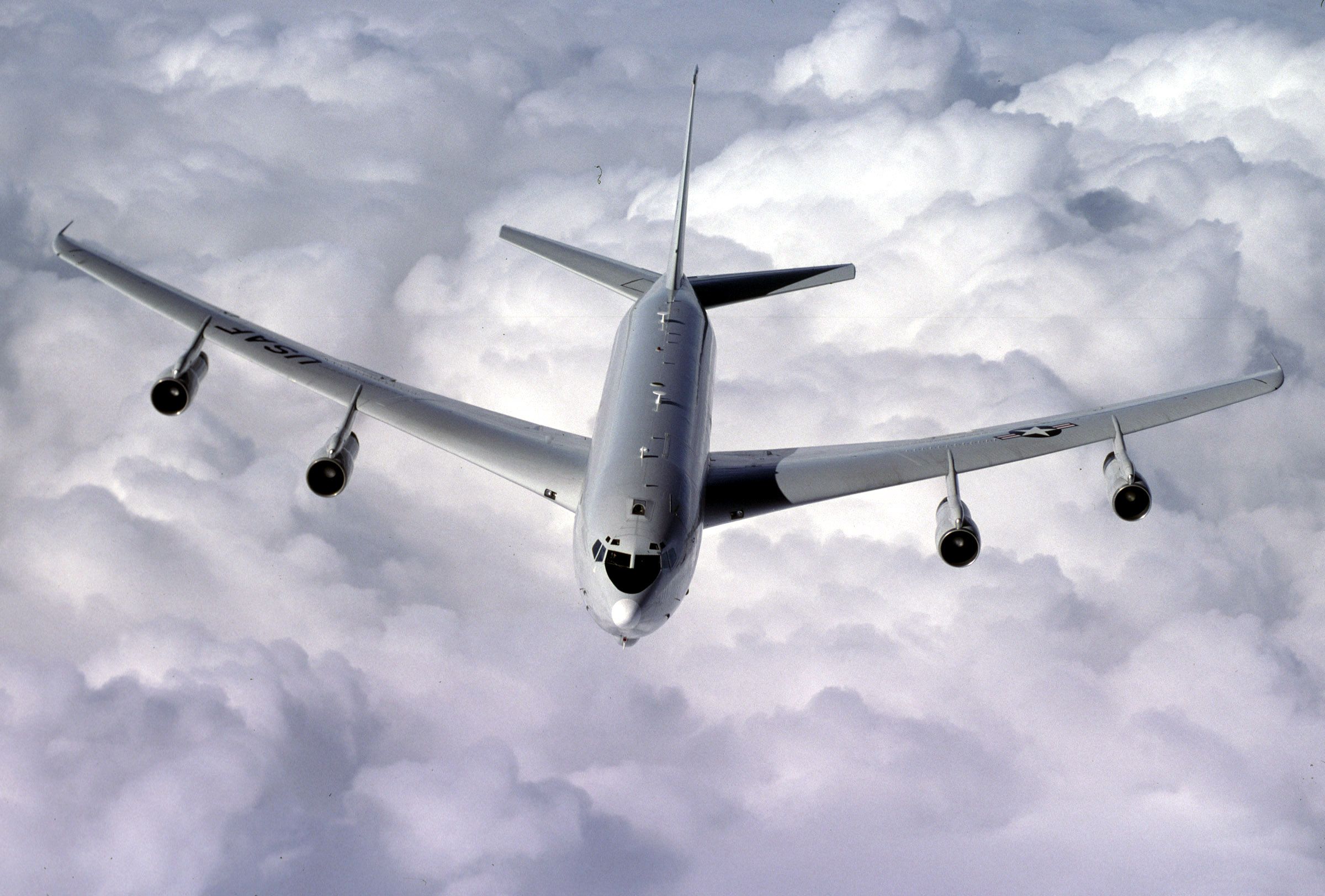 Photo of E-8C  in flight above clouds