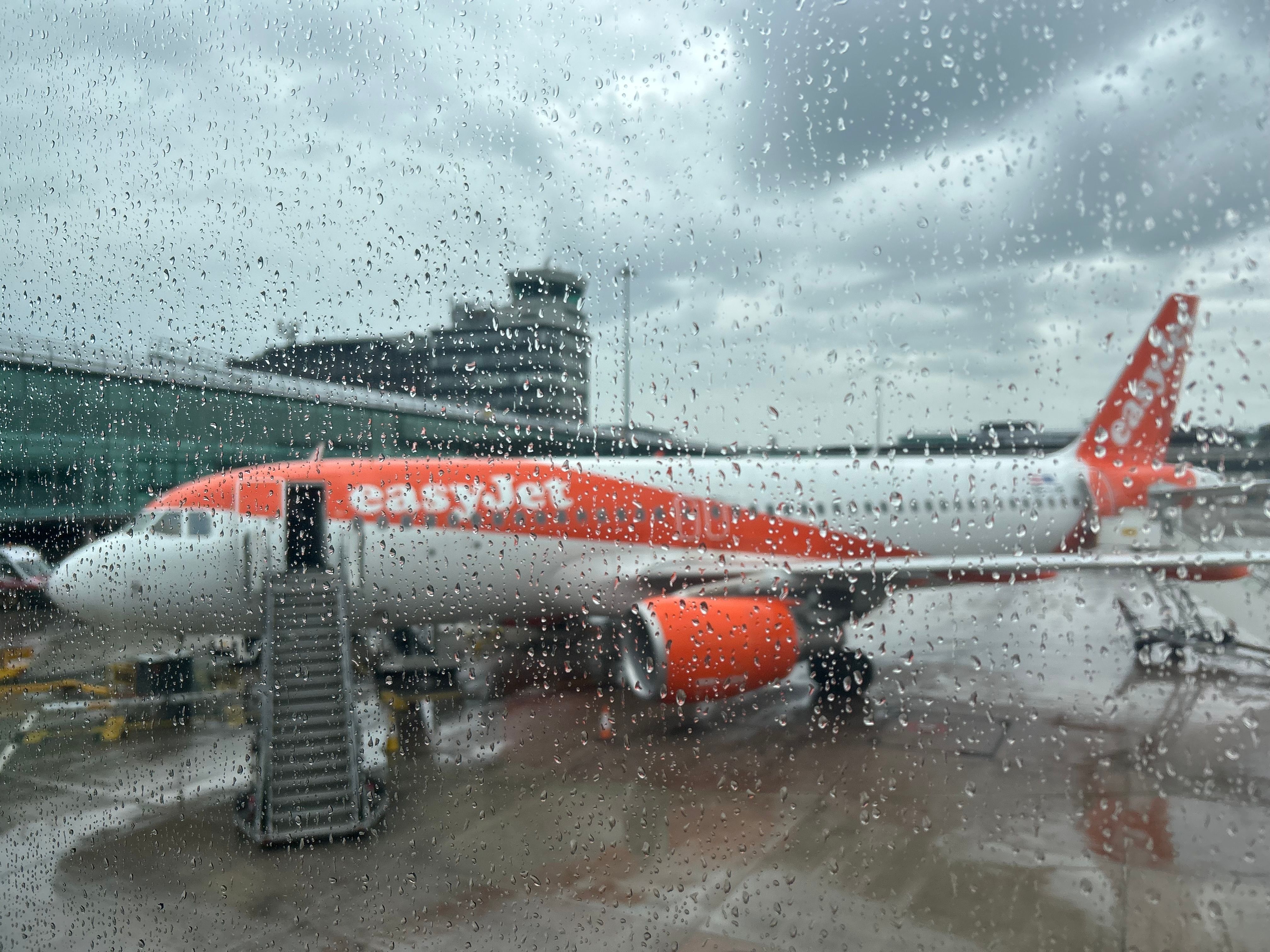 easyJet Airbus A320ceo at rainy Manchester Airport MAN shutterstock_2339171925