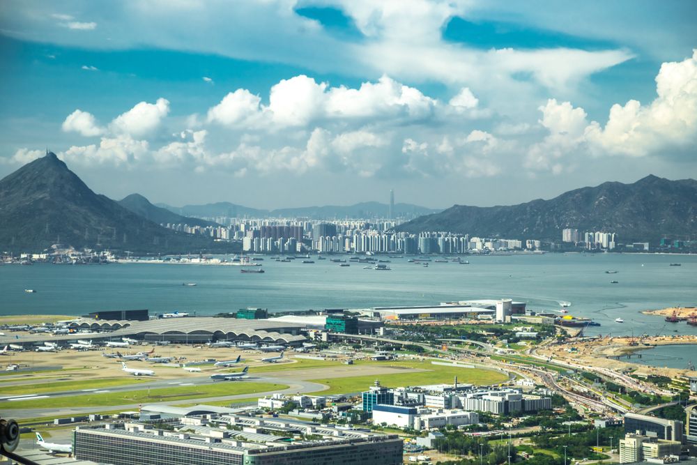 Aerial view of international airport with airplane parking in Hong Kong