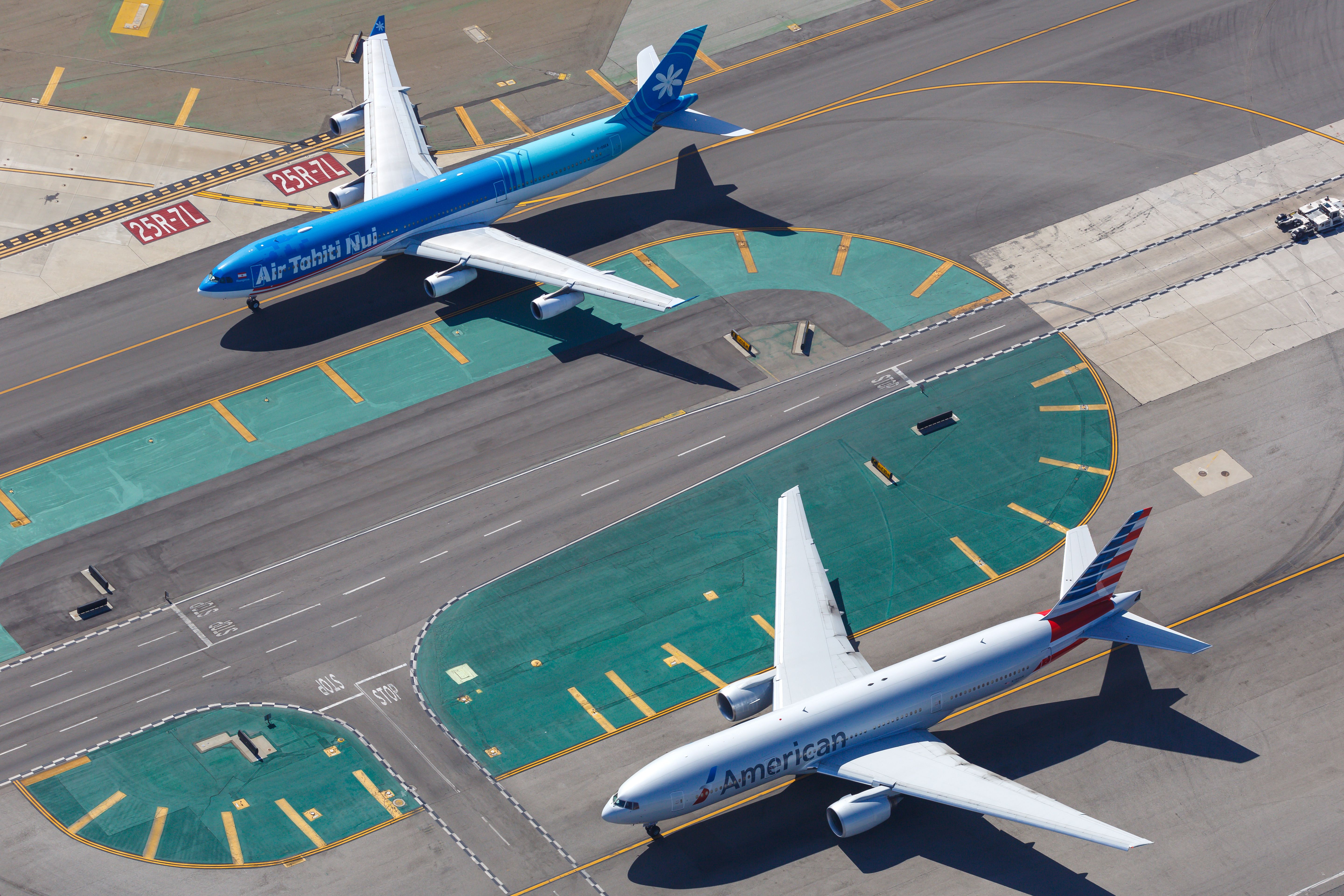 Air Tahiti Nui Airbus A340 Taxiing Next To American Airlines Boeing 777 At LAX