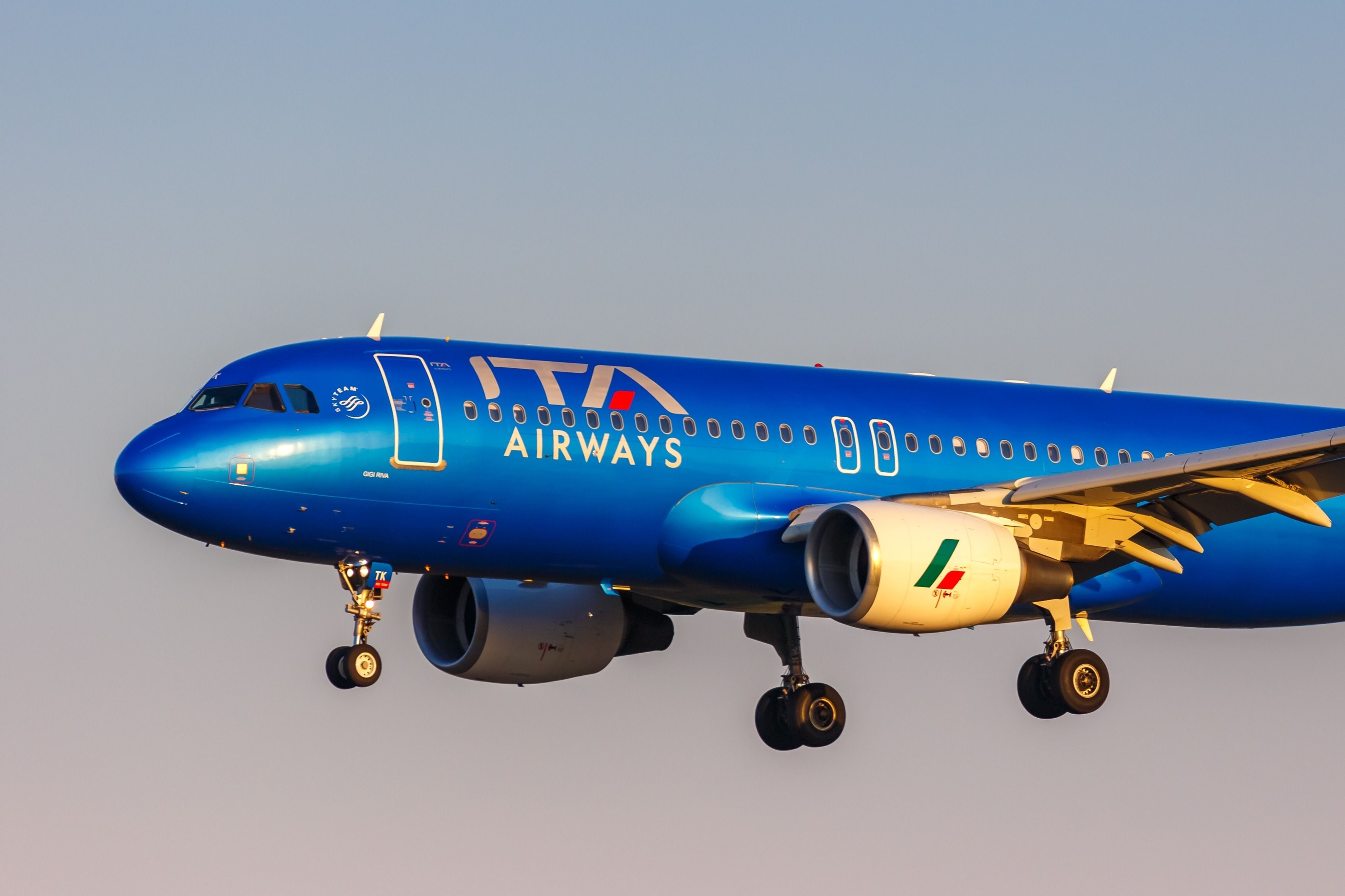 An ITA Airways plane at sunset