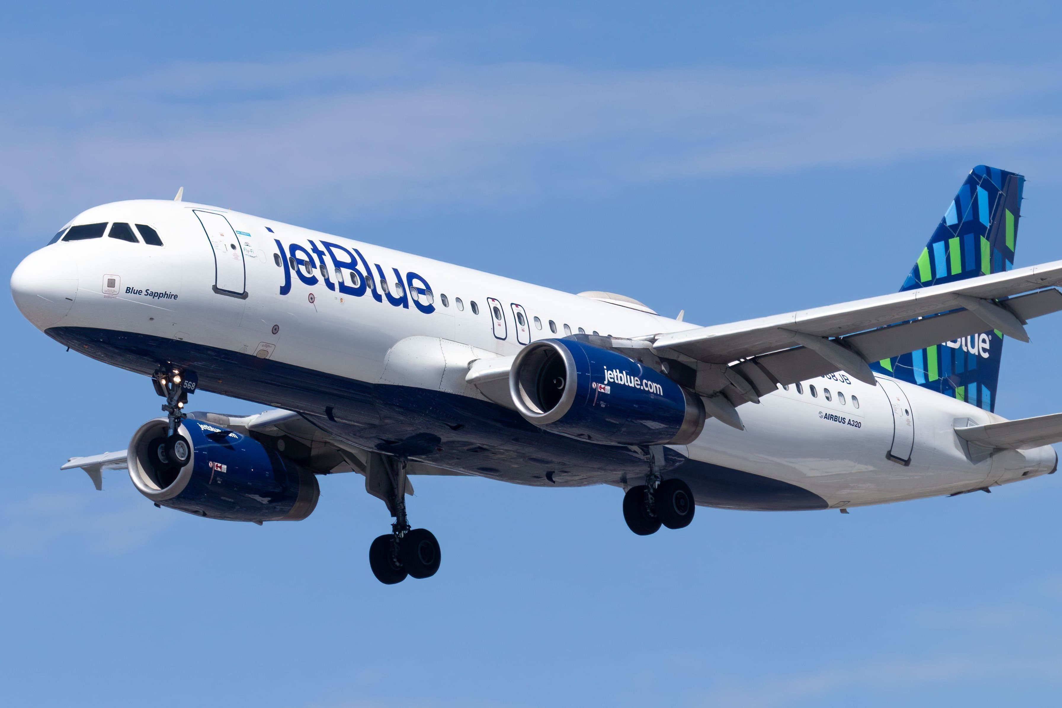 LOS ANGELES, US - Sep 03, 2022: A JetBlue Airlines aircraft soaring against a blue sky backdrop.