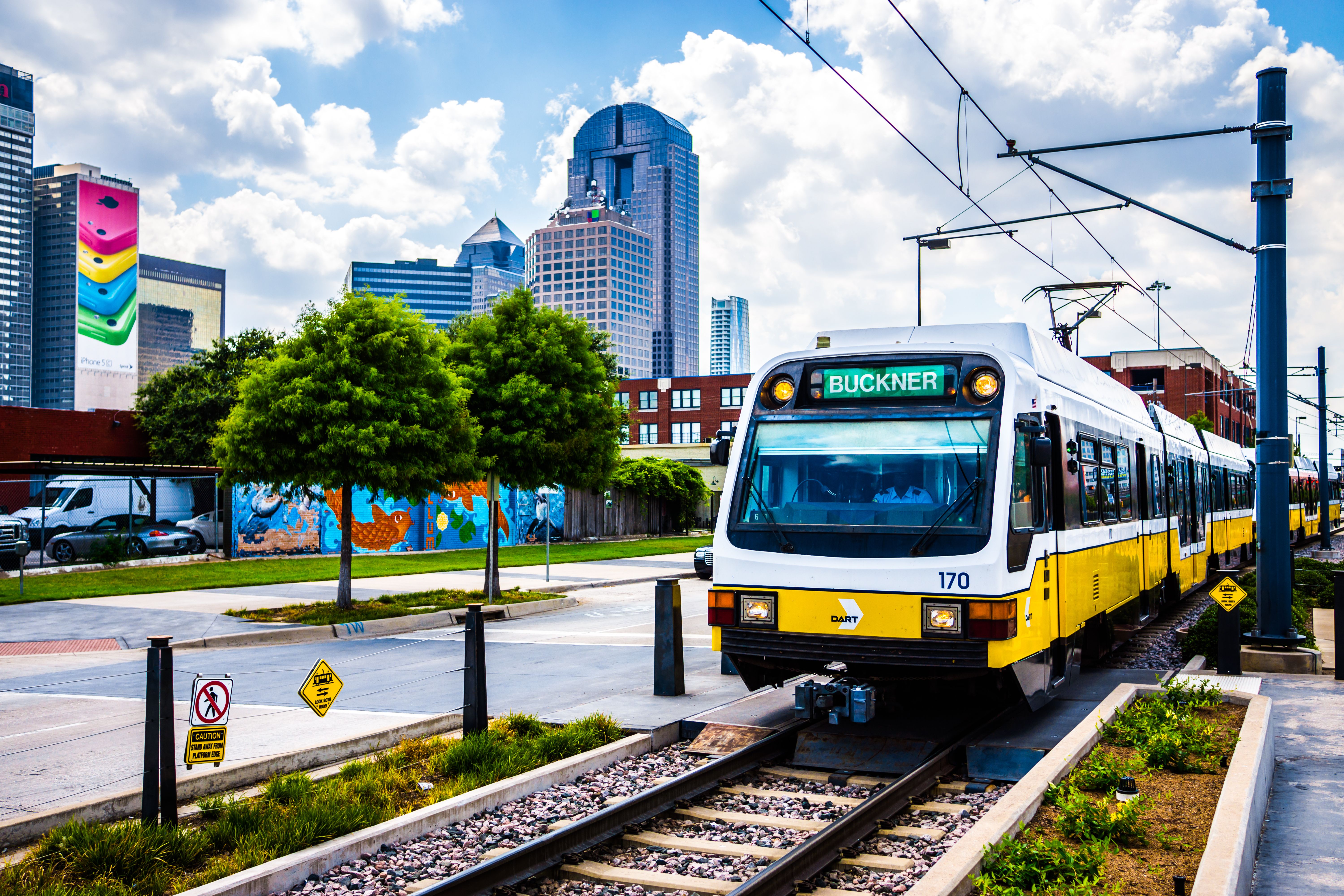 Dallas DART light rail train drives through Deep Ellum in Dallas, Texas