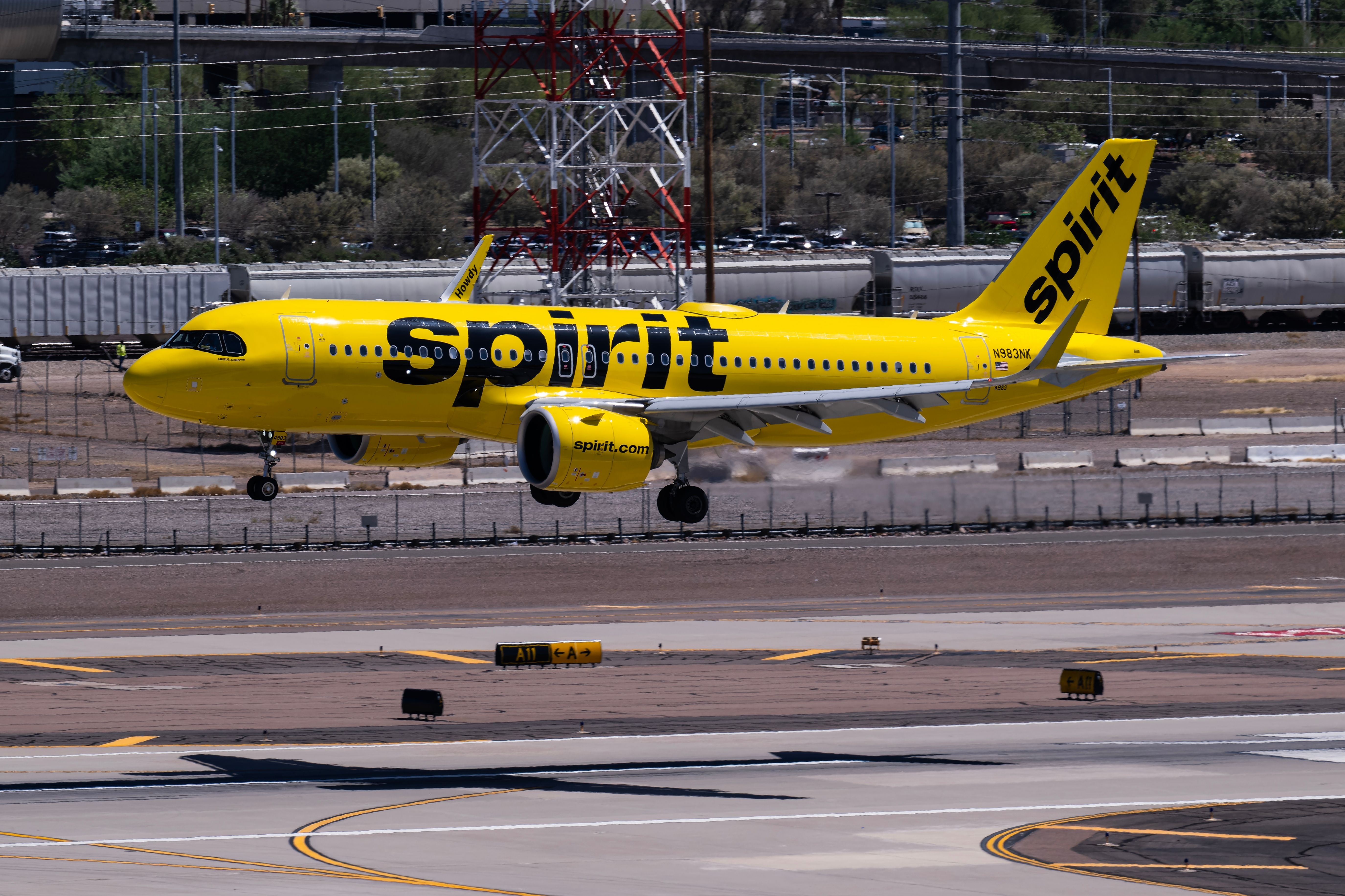Spirit Airlines Airbus A320neo landing at PHX shutterstock_2467375619