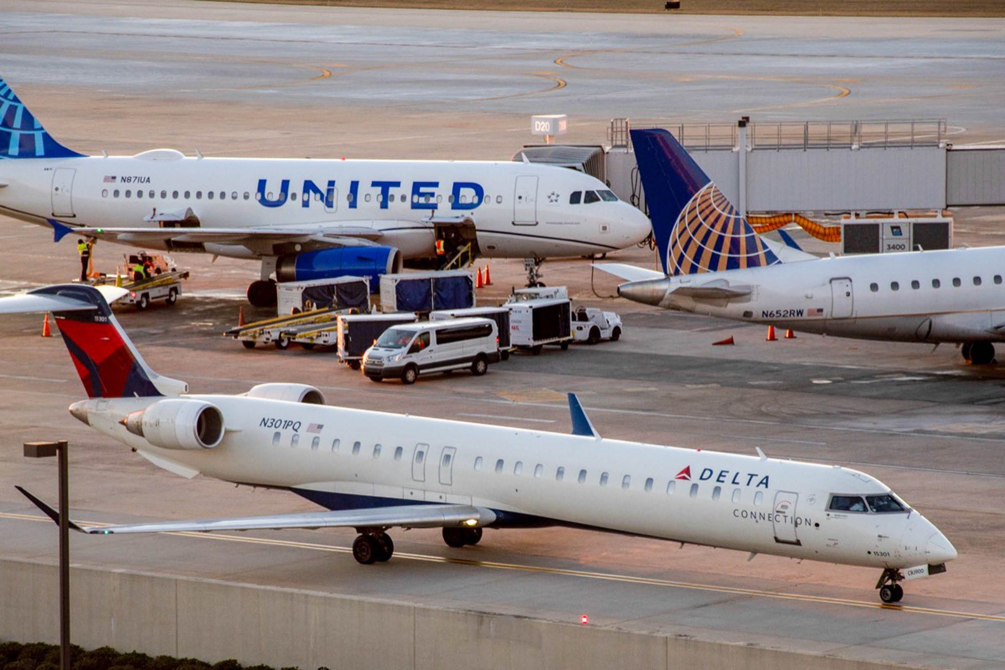 Delta Connection Bombardier CRJ900 with United Airlines aircraft in the distance at Raleigh-Durham International Airport.