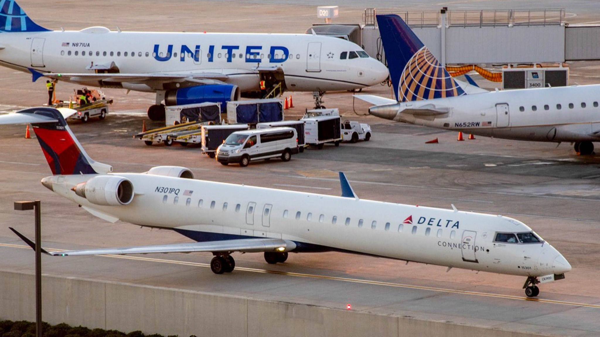 Delta Connection Bombardier CRJ900 with United Airlines aircraft in the distance at Raleigh-Durham International Airport.