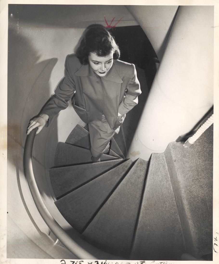 Woman walking up the B-377 spiral staircase