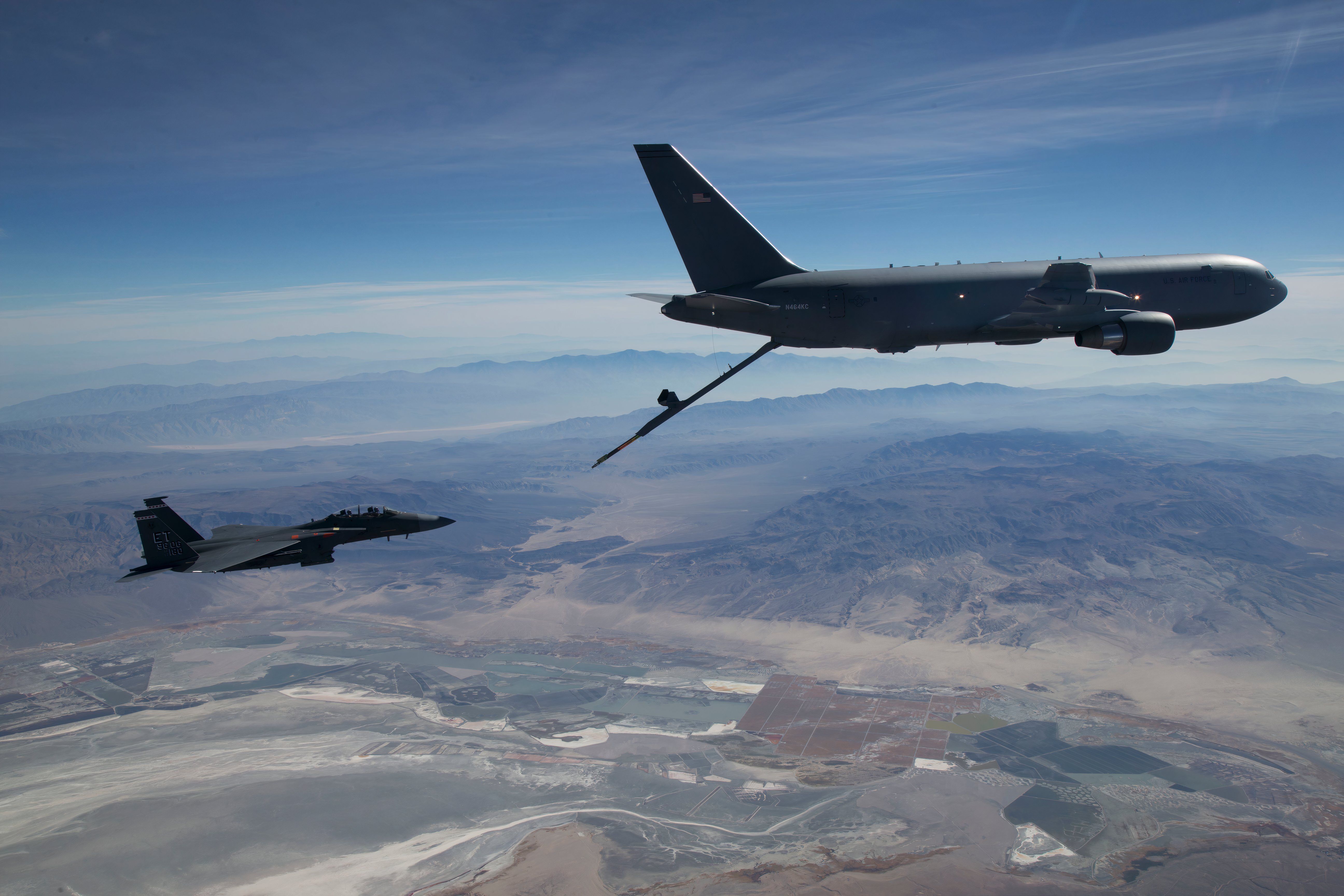 A KC-46A Pegasus aerial refueling aircraft connects with an F-15 Strike Eagle