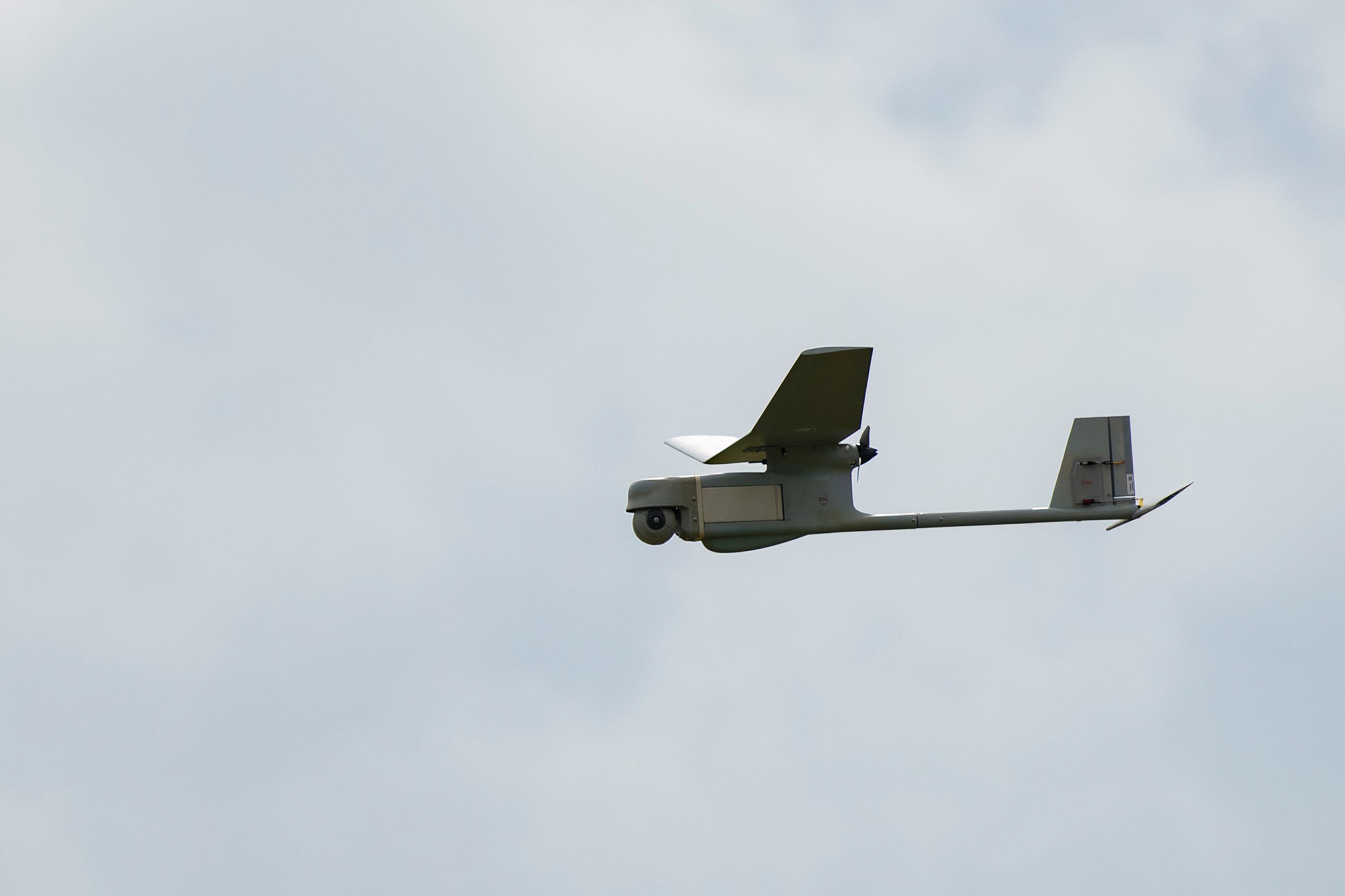 A U.S. Air Force RQ-11B Raven small unmanned aerial system flies over the flightline at Spangdahlem Air Base, Germany,