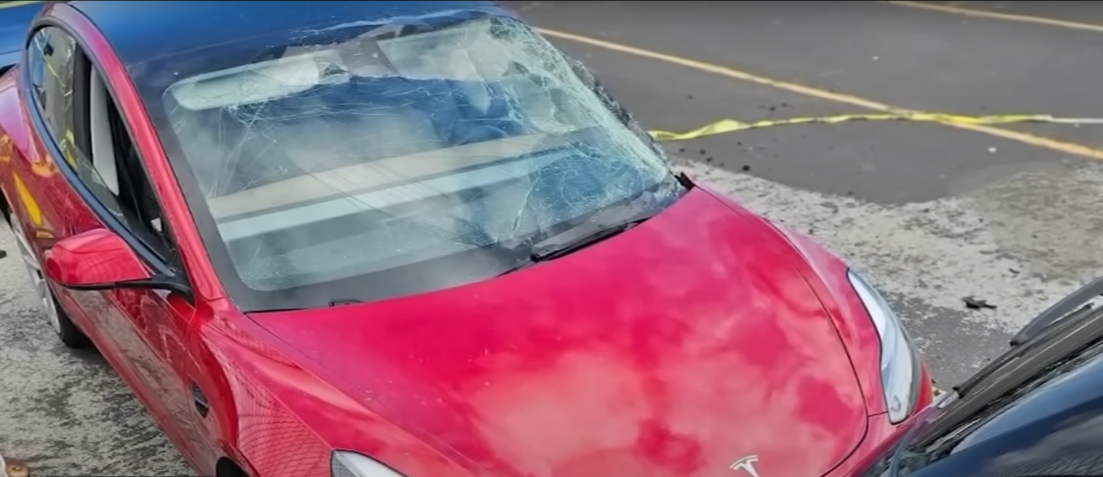 Red Tesla totaled after United Airlines Boeing 777-200ER tire incident.