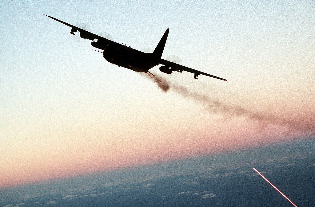 AC-130_gunship_firing_broadside_at_dusk