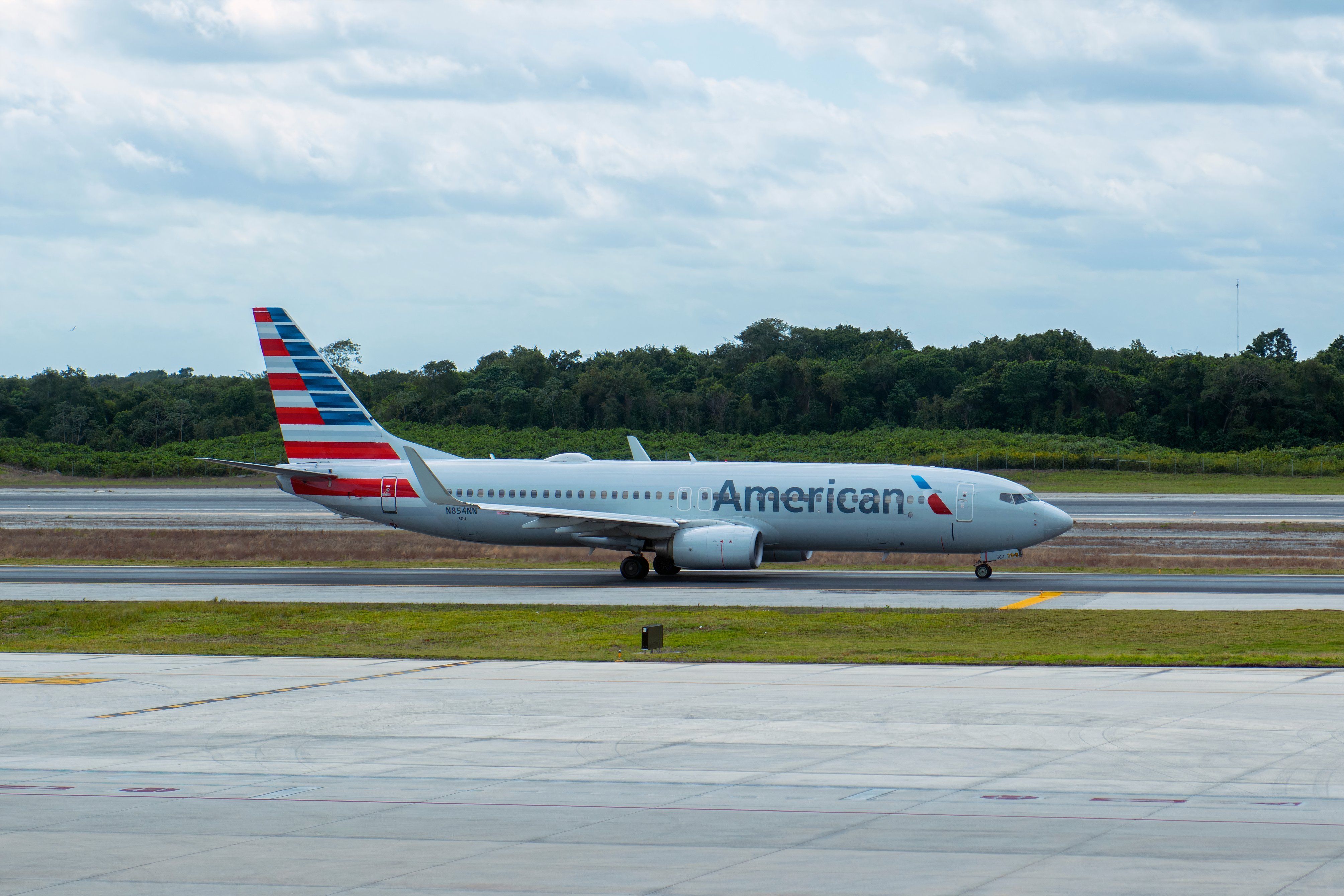 An American Airlines airplane taxis the runway at Cancun International Airport