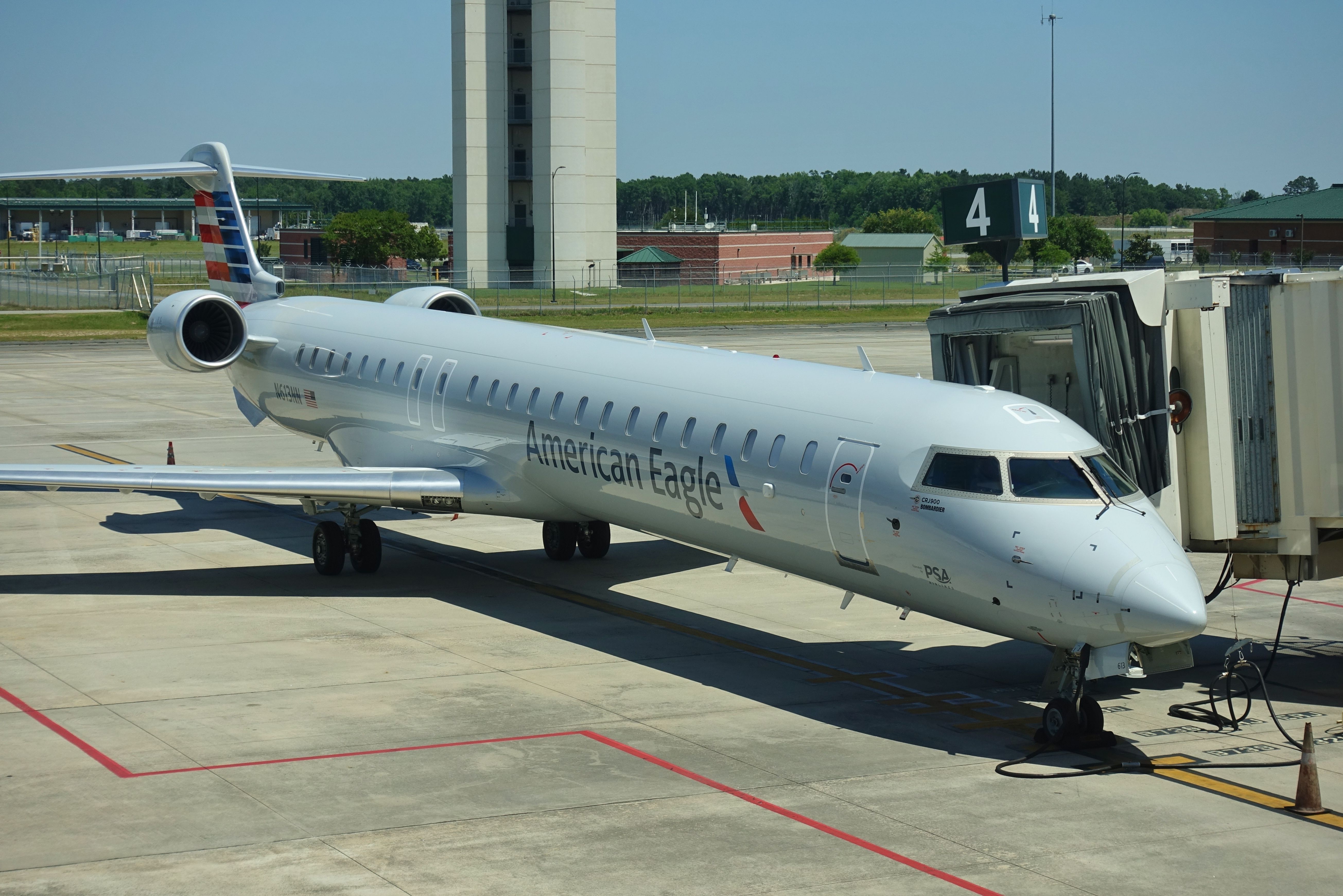 American Eagle Mitsubishi CRJ900 on the ground shutterstock_1728781438