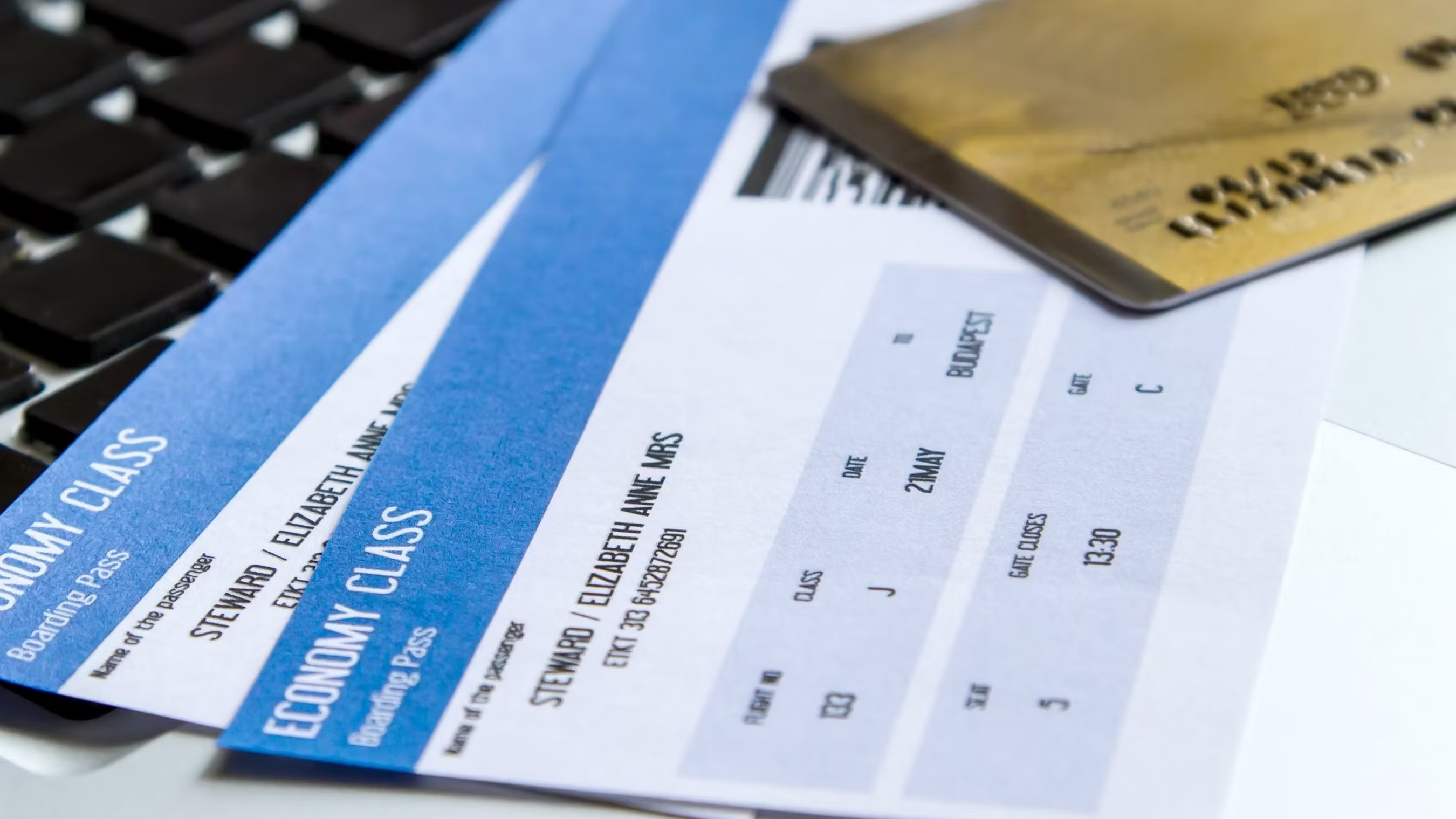 A generic photo of a credit card on top of two boarding passes.