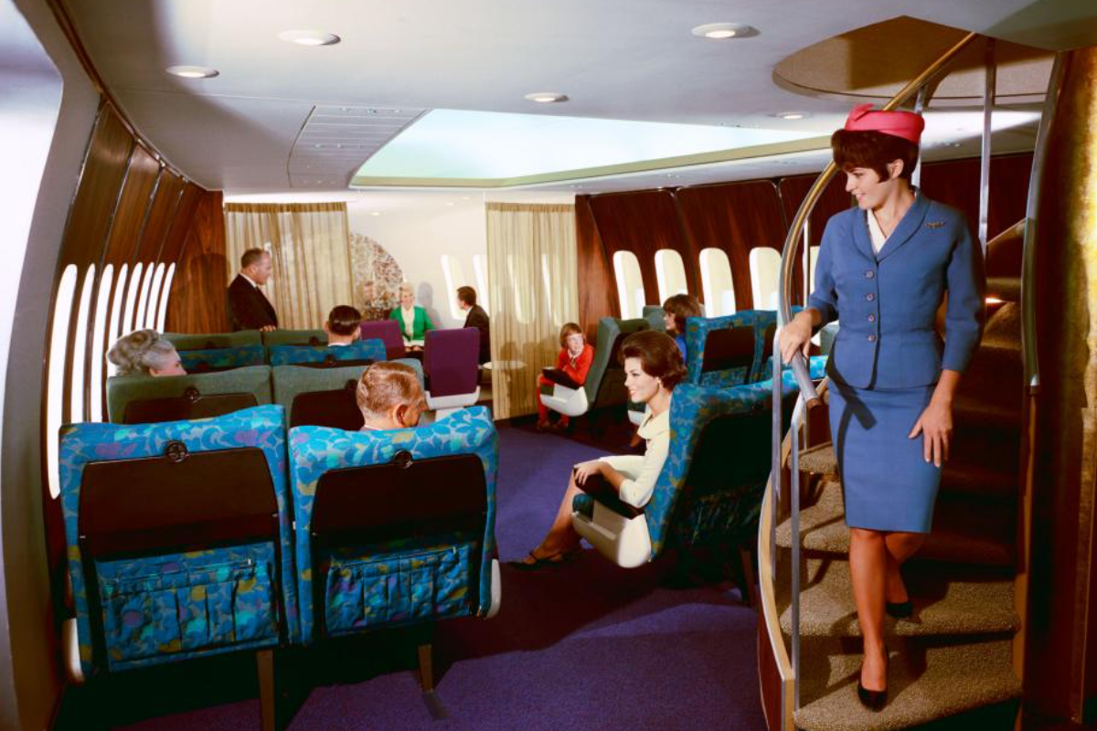 Air hostess using the early spiral staircase of the B-747