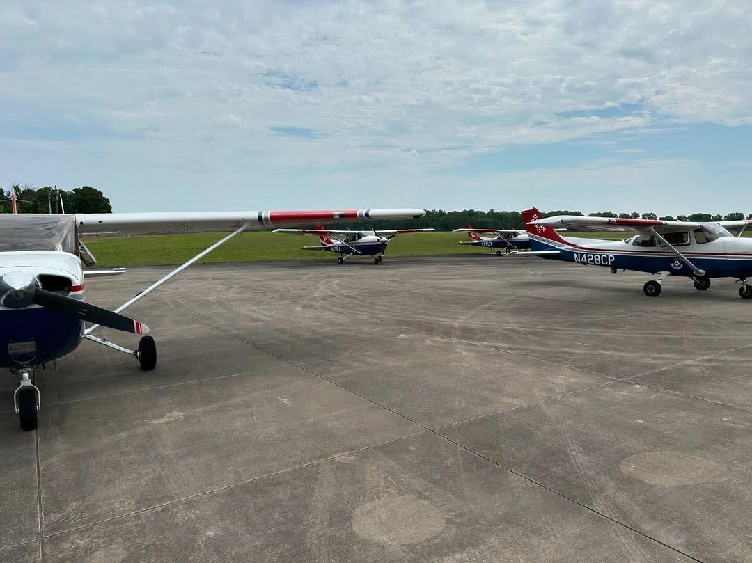 Several Civil Air Patrol Cessnas on a ramp.