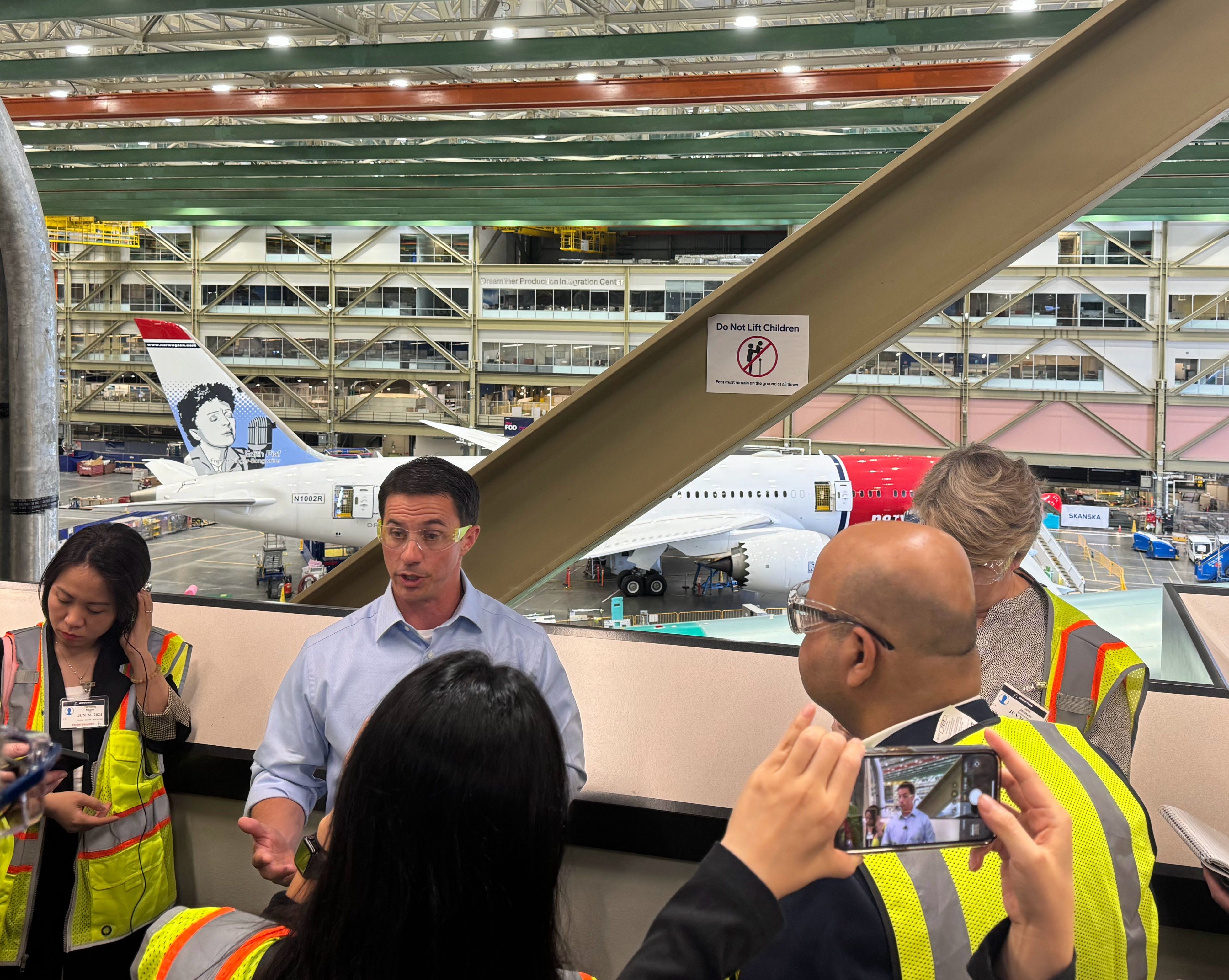 Boeing Vice President and general manager of the 787 program Scott Stocker in front of Boeing 787 Dreamliner aircraft on the production line undergoing testing.