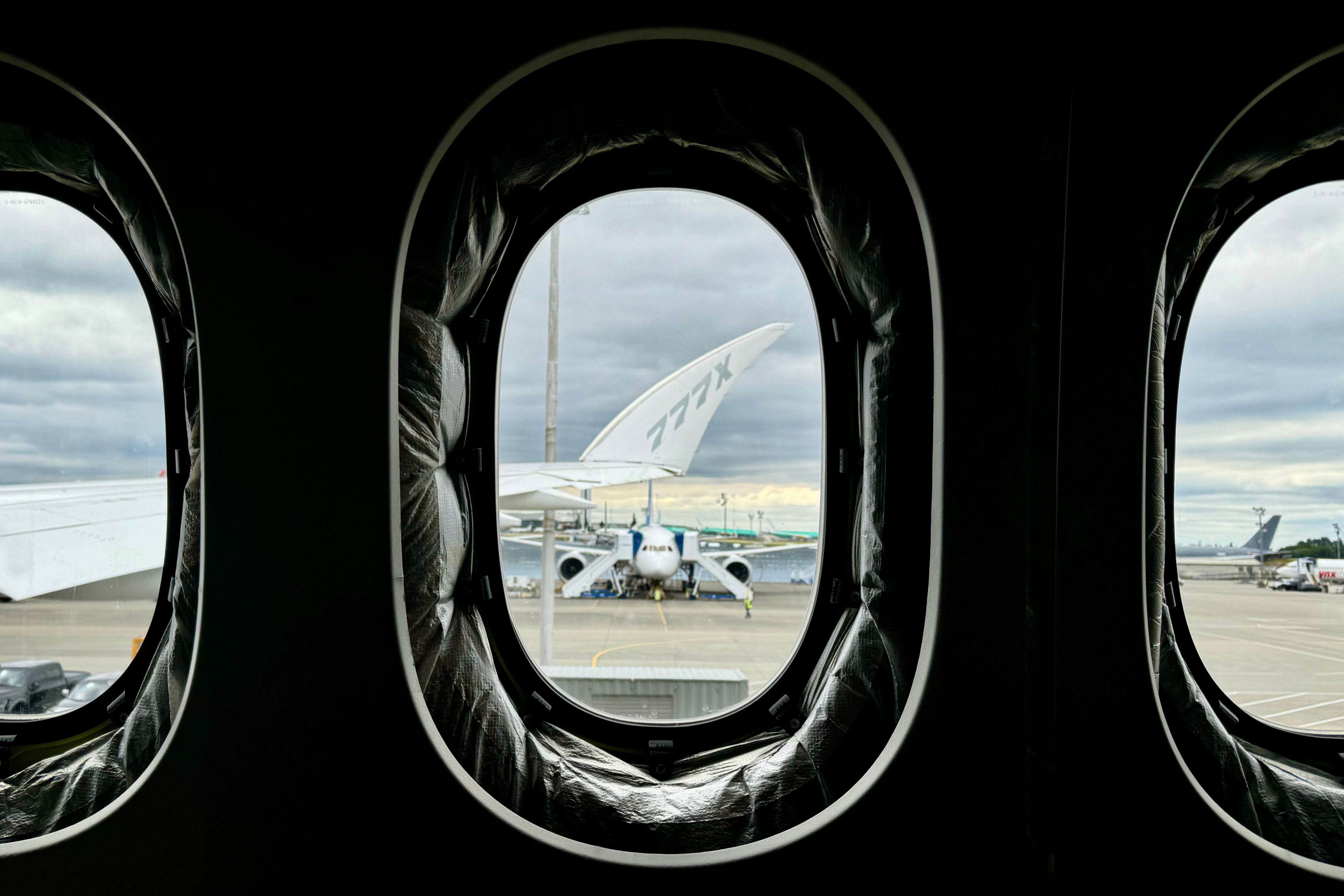 The folding wingtip of a Boeing 777X seen from inside the cabin with its large windows