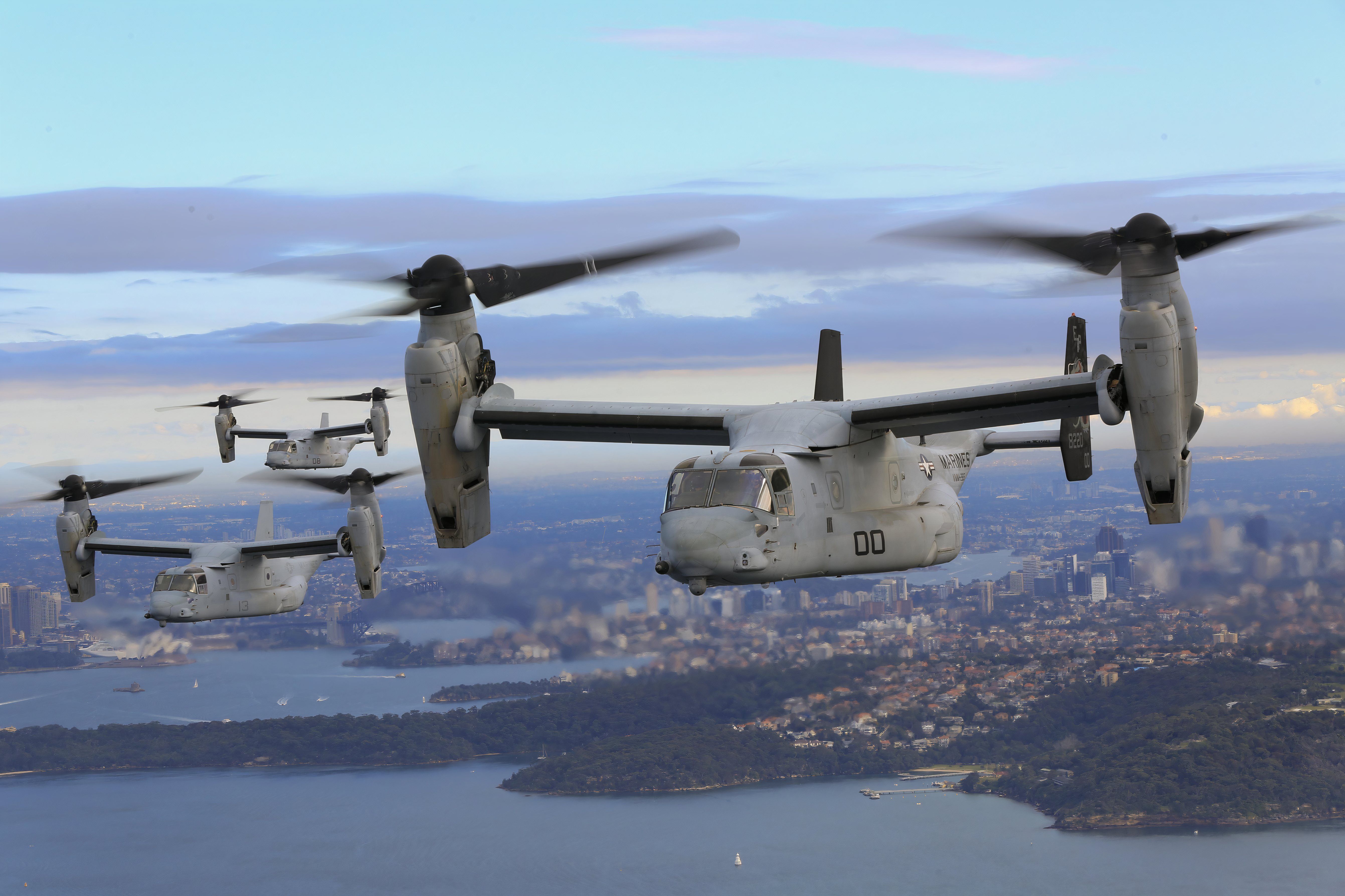 Photo of three V-22 Ospreys in takeof:landing mode