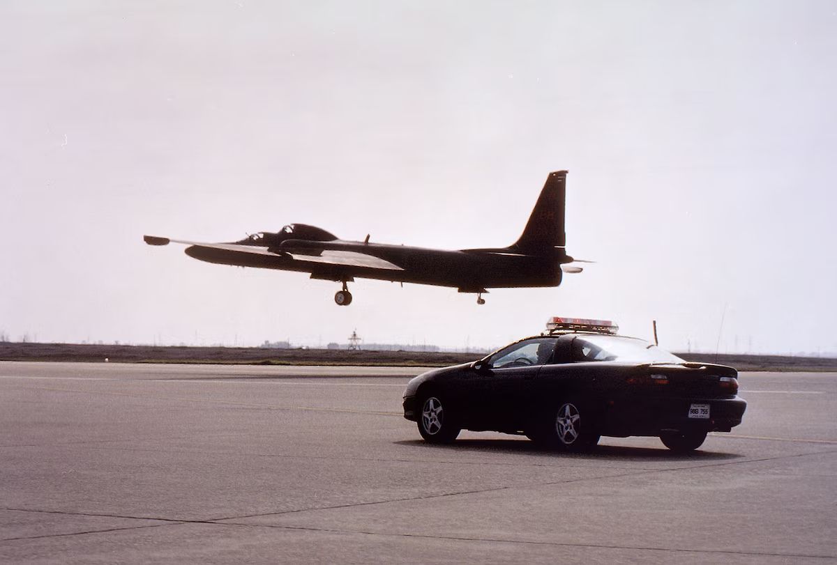 Photo of U-2 landing with chase car following