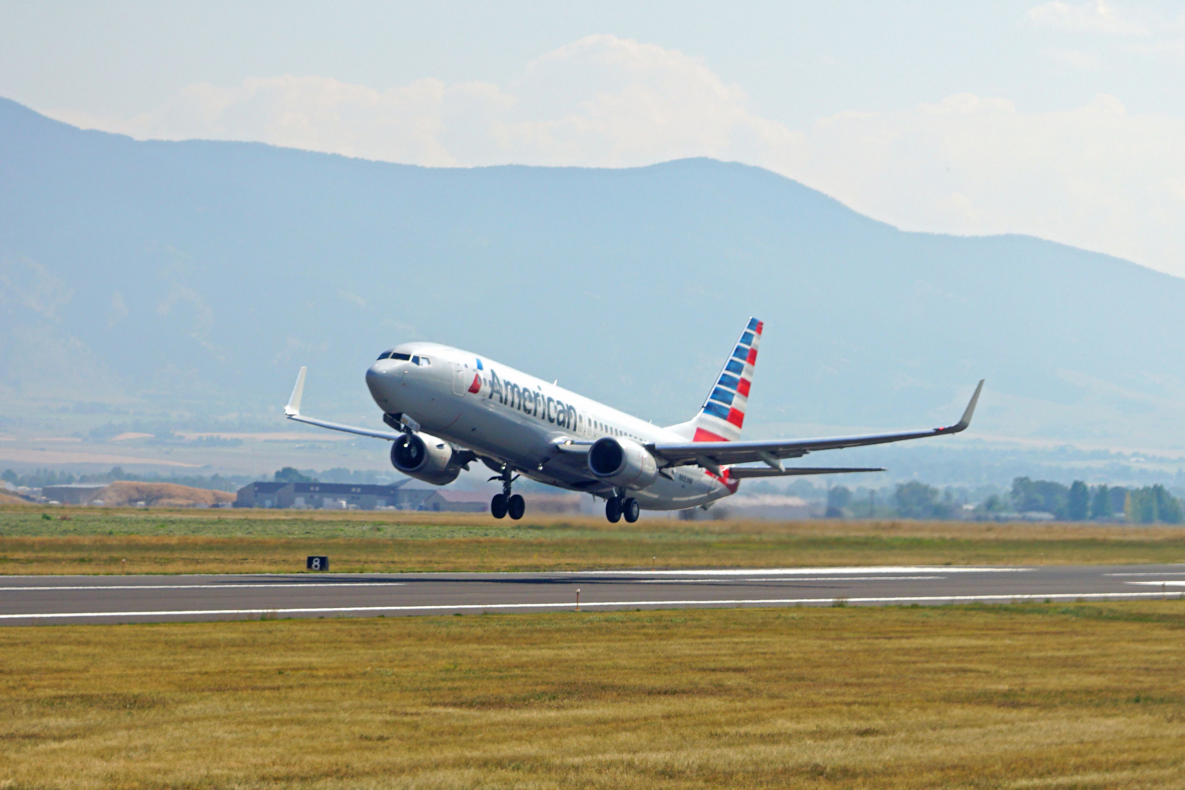 View of an American Airlines (AA) airplane taking off from Bozeman Yellowstone International Airport (BZN) in Gallatin County, Montana, near Yellowstone National Park.