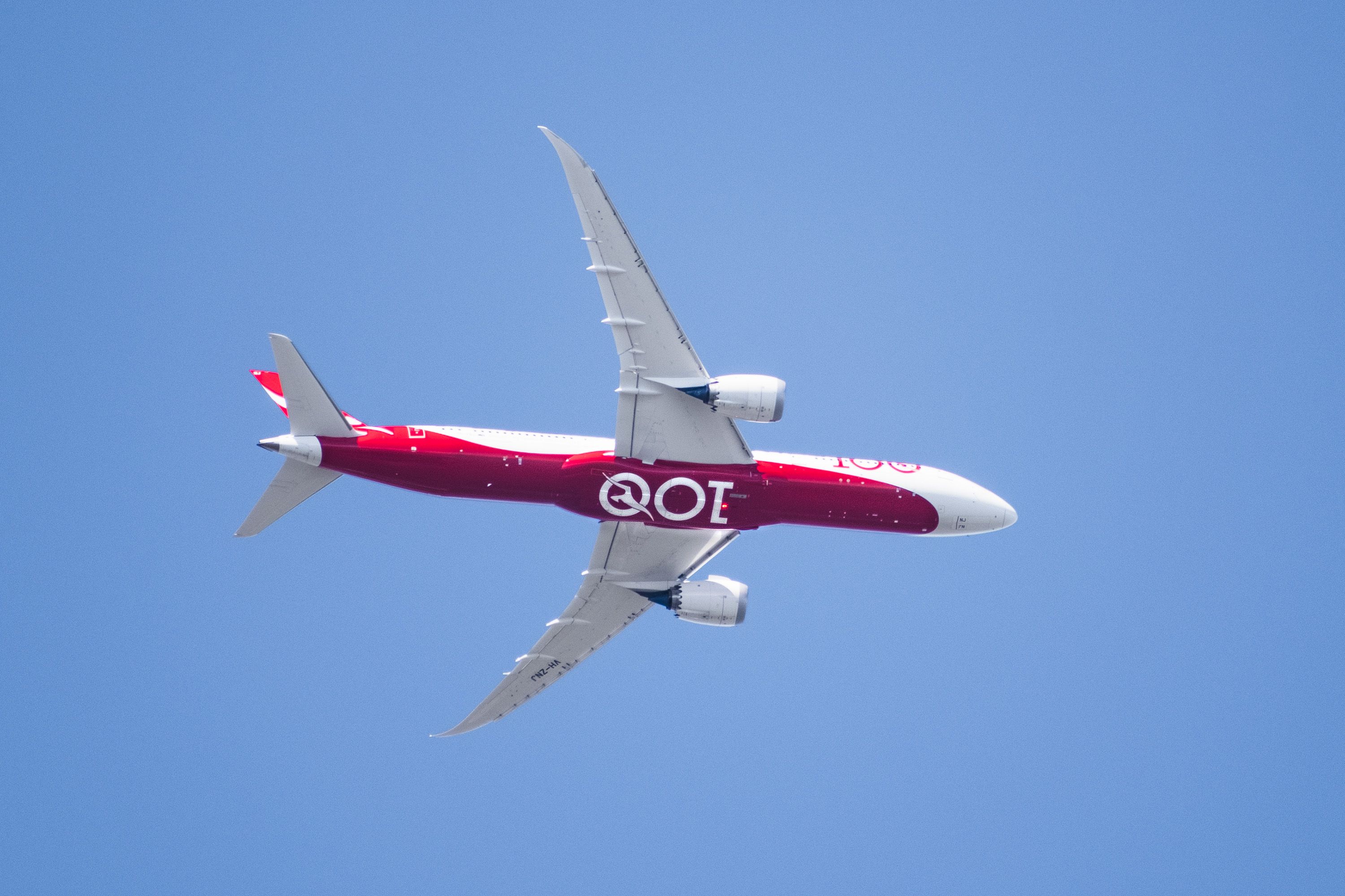 Mar 19, 2020 Palo Alto / CA / USA - View from below of Qantas Airways (100 years anniversary livery) Dreamliner aircraft starting the descent for landing at San Francisco International Airport (SFO);