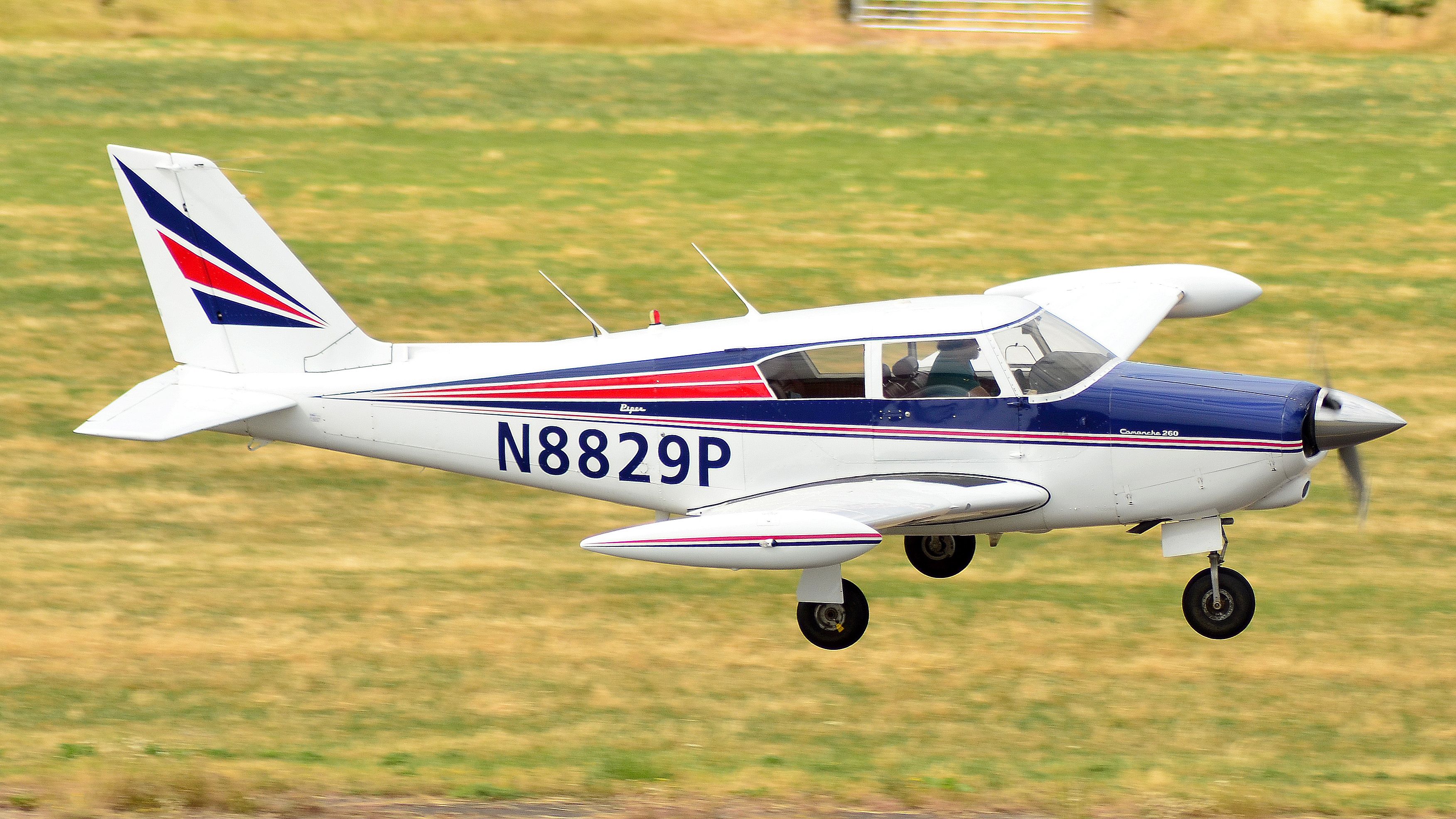 A Piper PA-24 Comanche vintage light aircraft landing