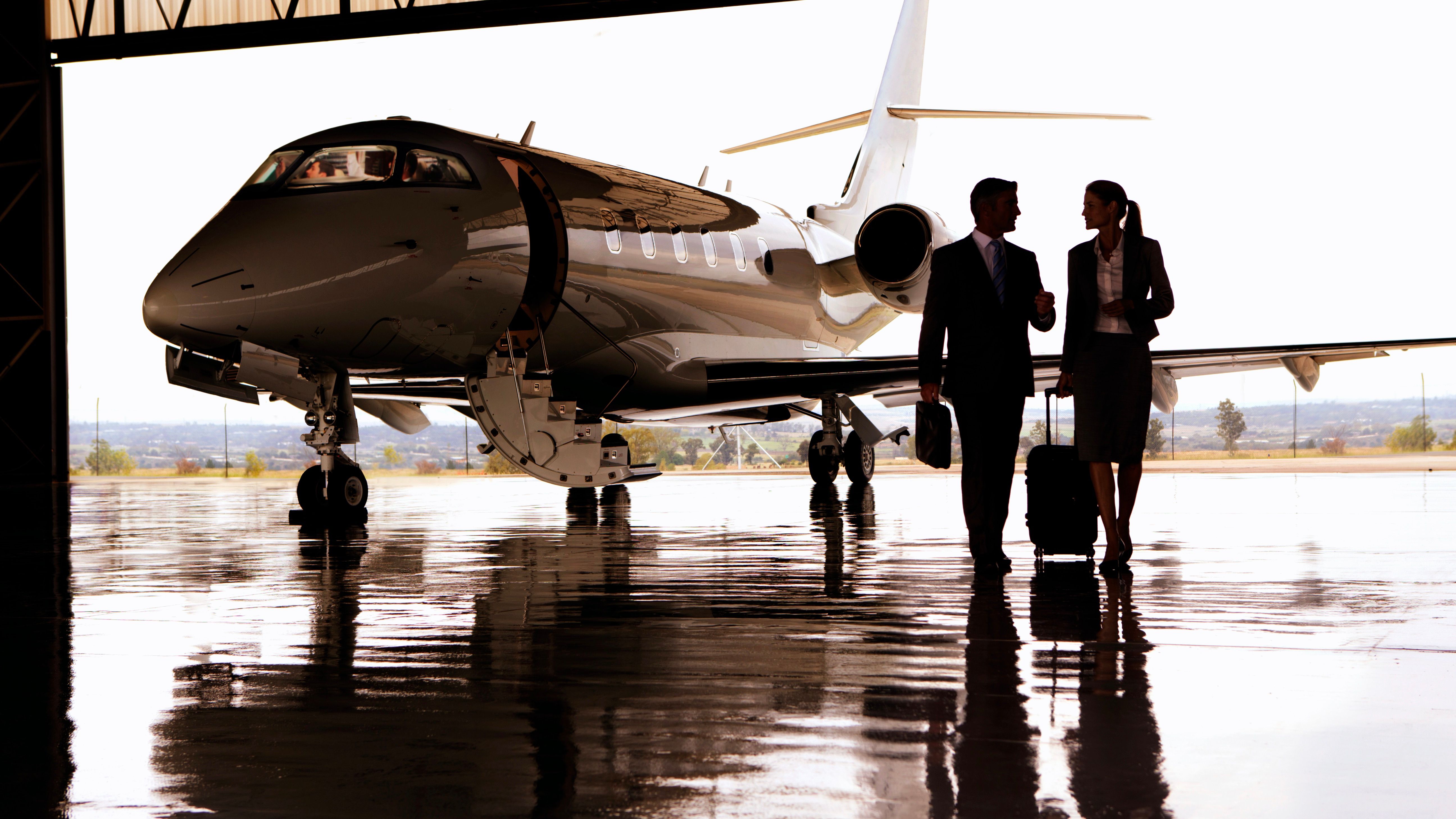 private jet in hangar with business executive passengers