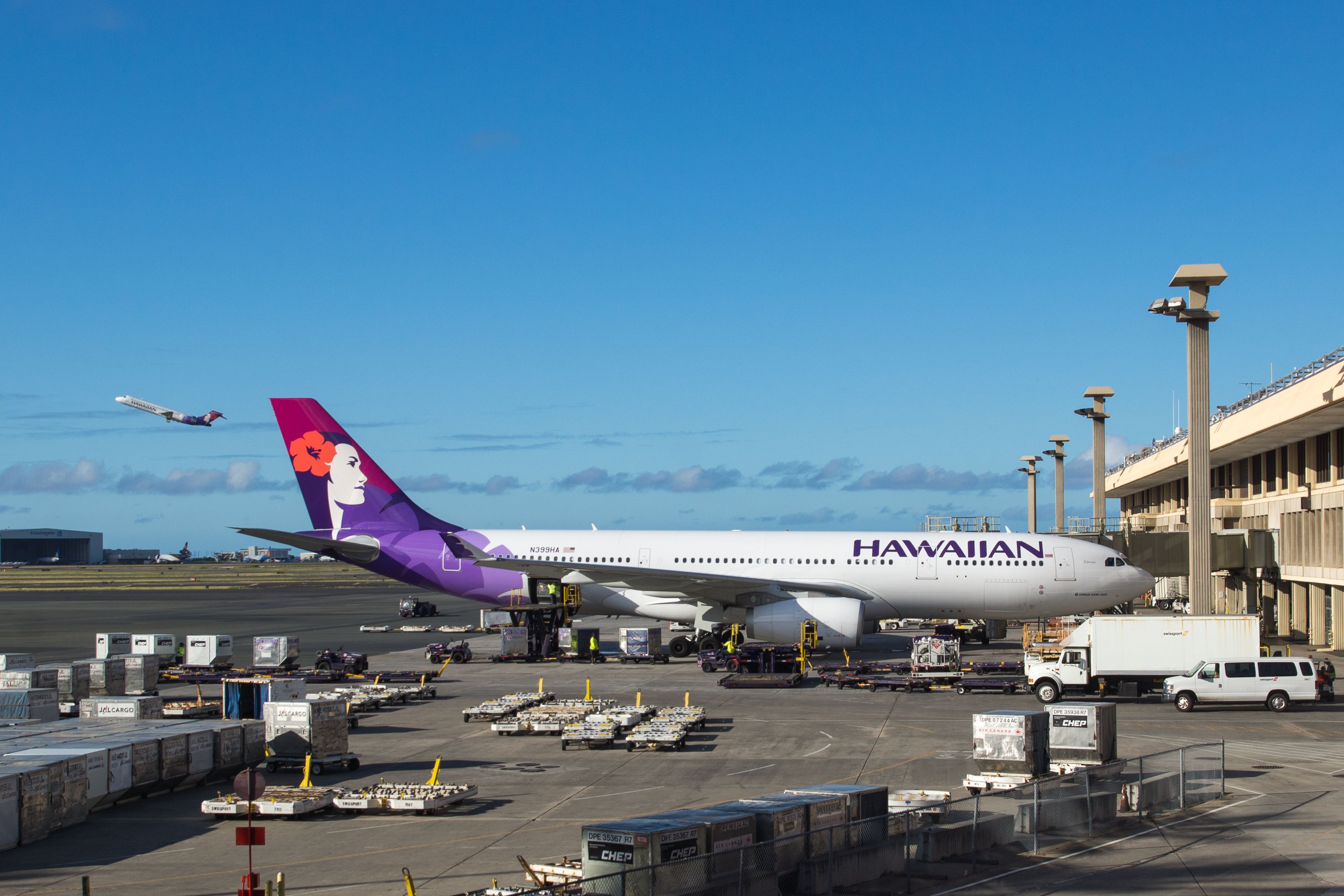 Hawaiian Airlines planes on the ground and in the air at Honolulu International Airport (HNL) in Hawaii 