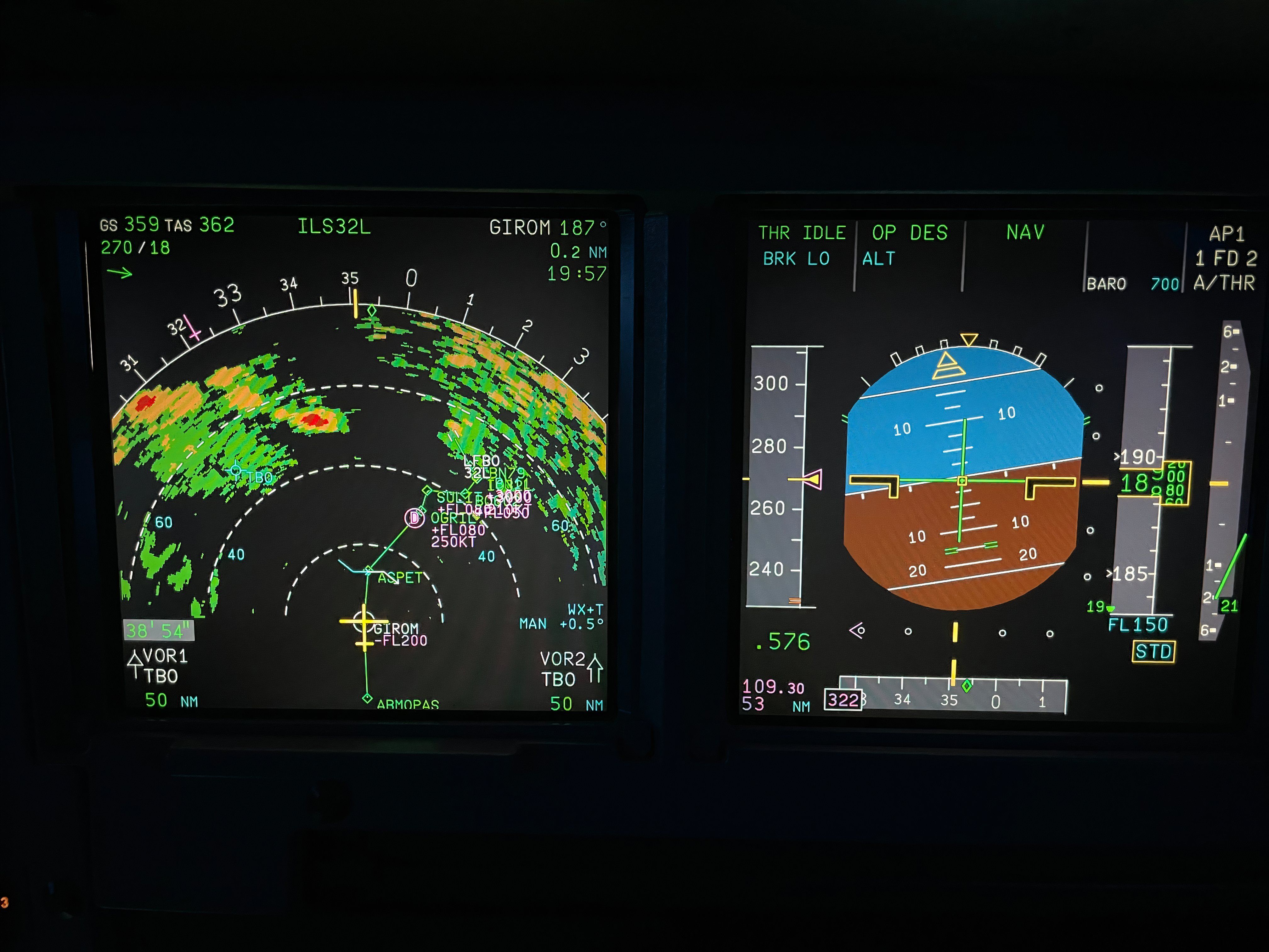 Instruments displaying primary flight information, and navigation display with weather radar in the cockpit of a modern airliner