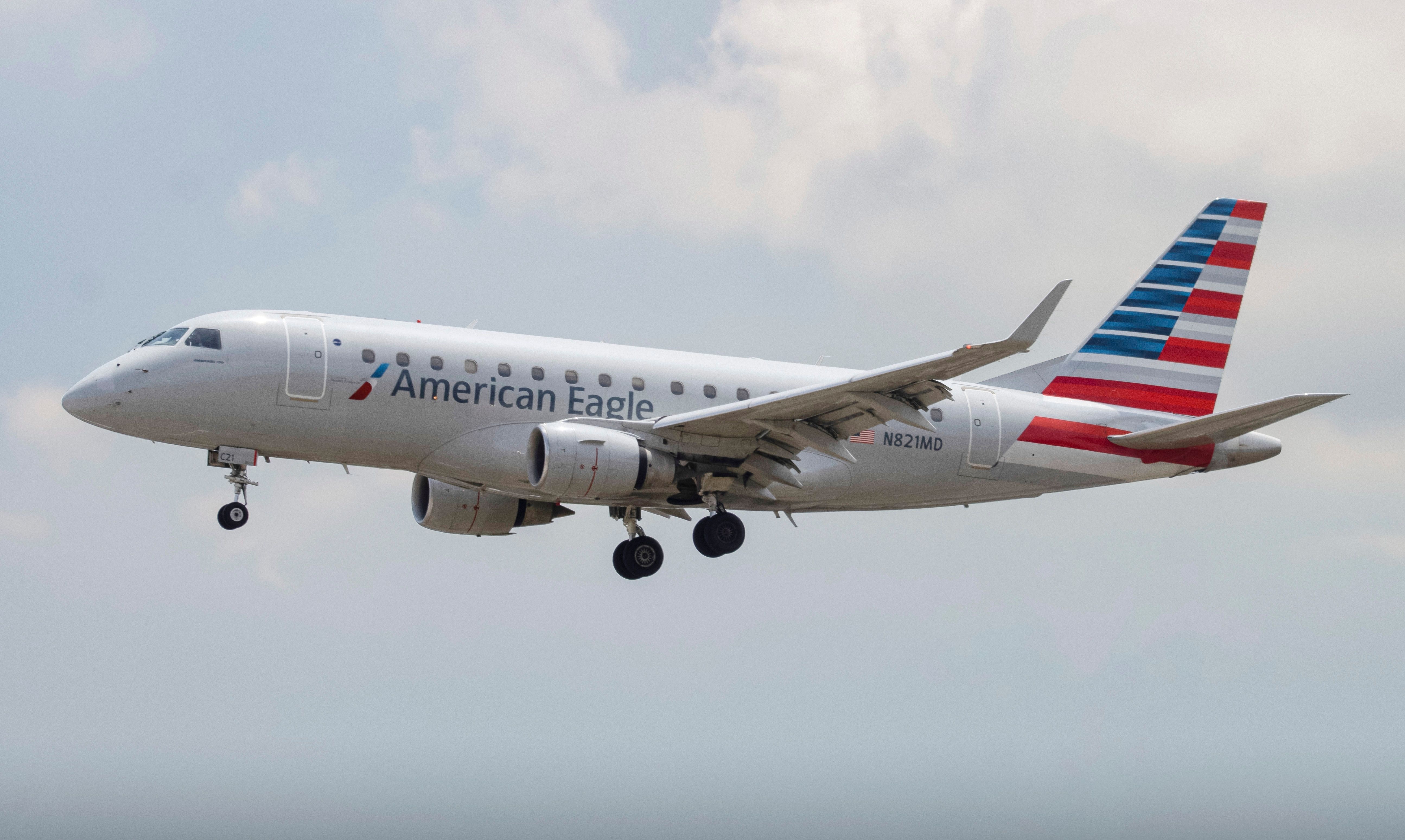 An American Eagle Embraer E170 flying in the sky