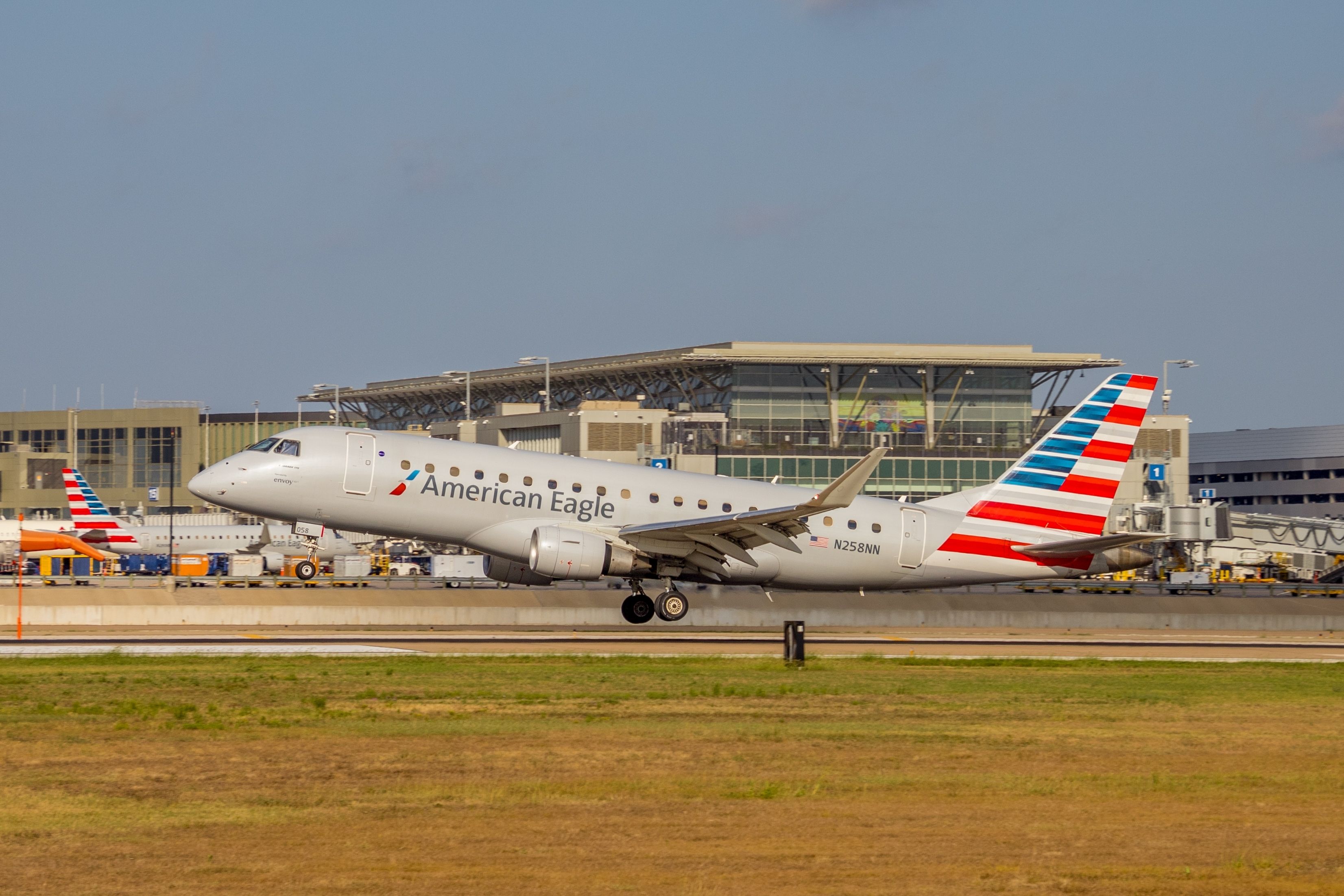 Embraer E175 N258NN of American Eagle (Envoy Air) taking off from Austin-Bergstrom International Airport.