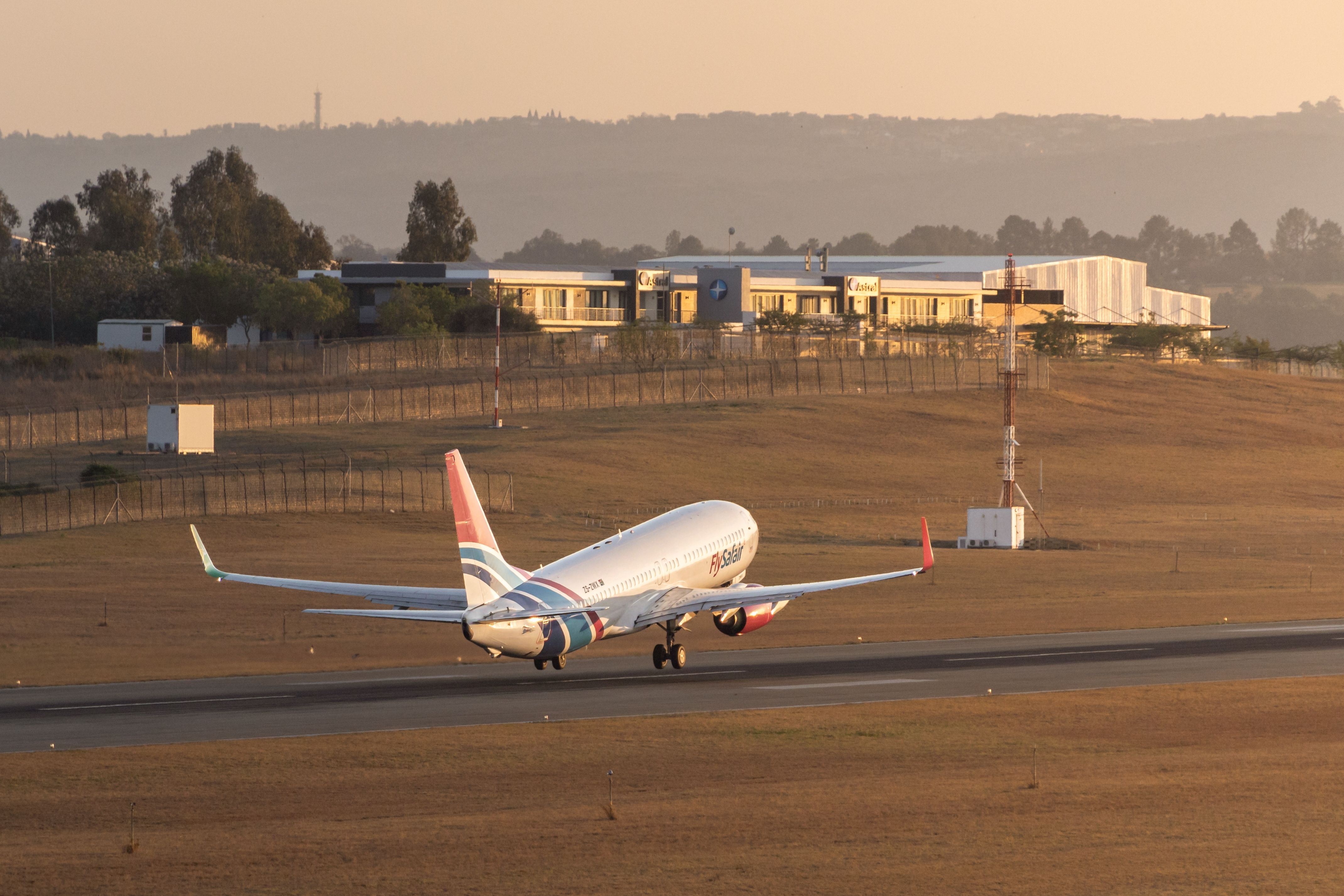 South Africa - September 30 2023: FlySafair B737-800 departing Lanseria International Airport into the sunset