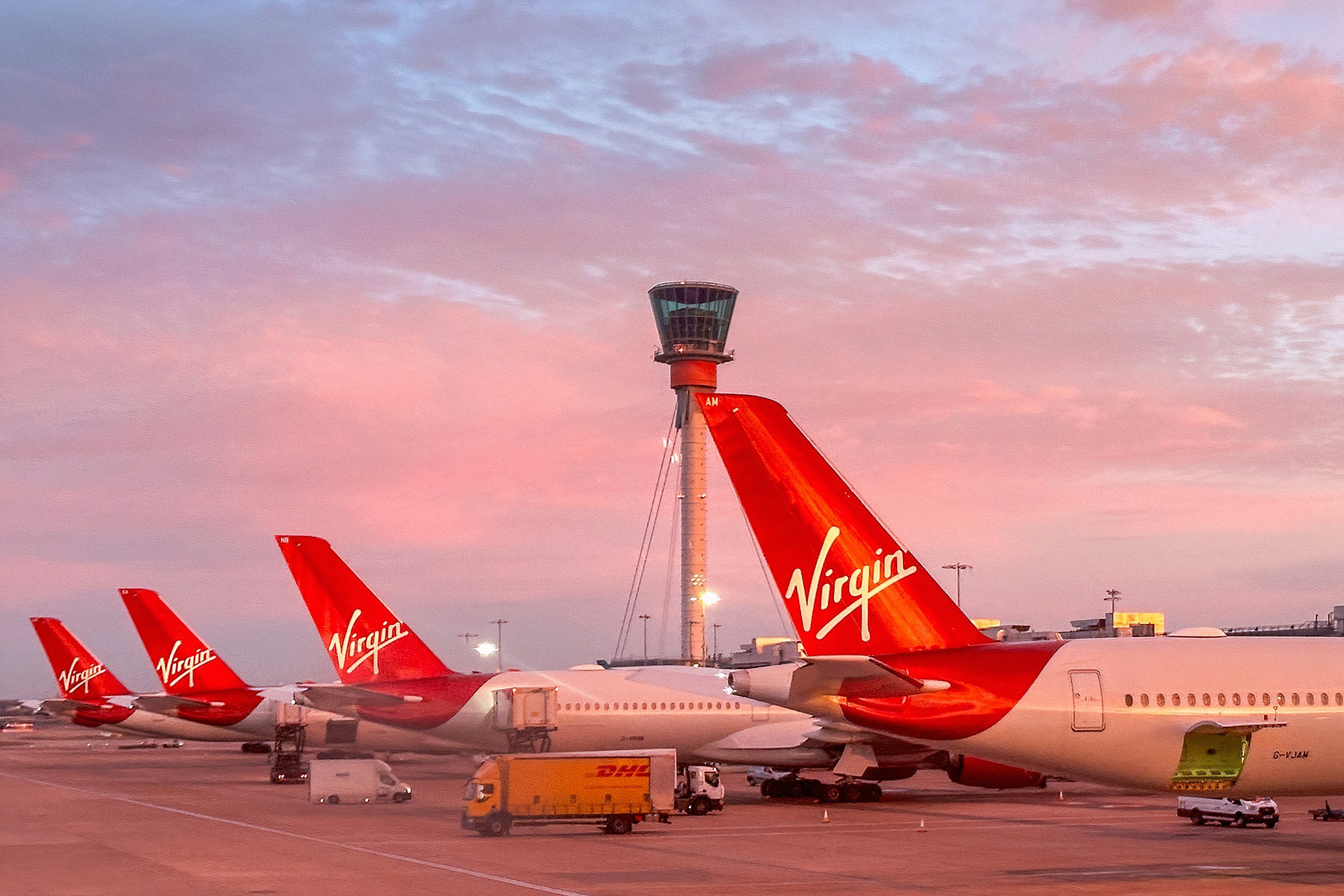 Tail fins of Virgin Atlantic Airways planes at London Heathrow Airport at dawn