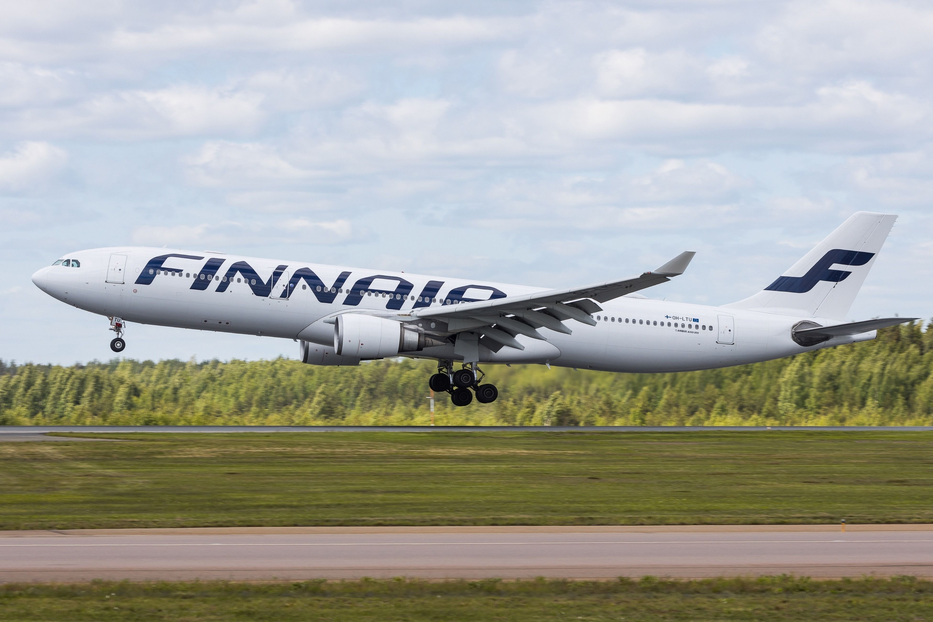 Airbus A330 of Finnish airline Finnair touching down on the runway in Helsinki (HEL)