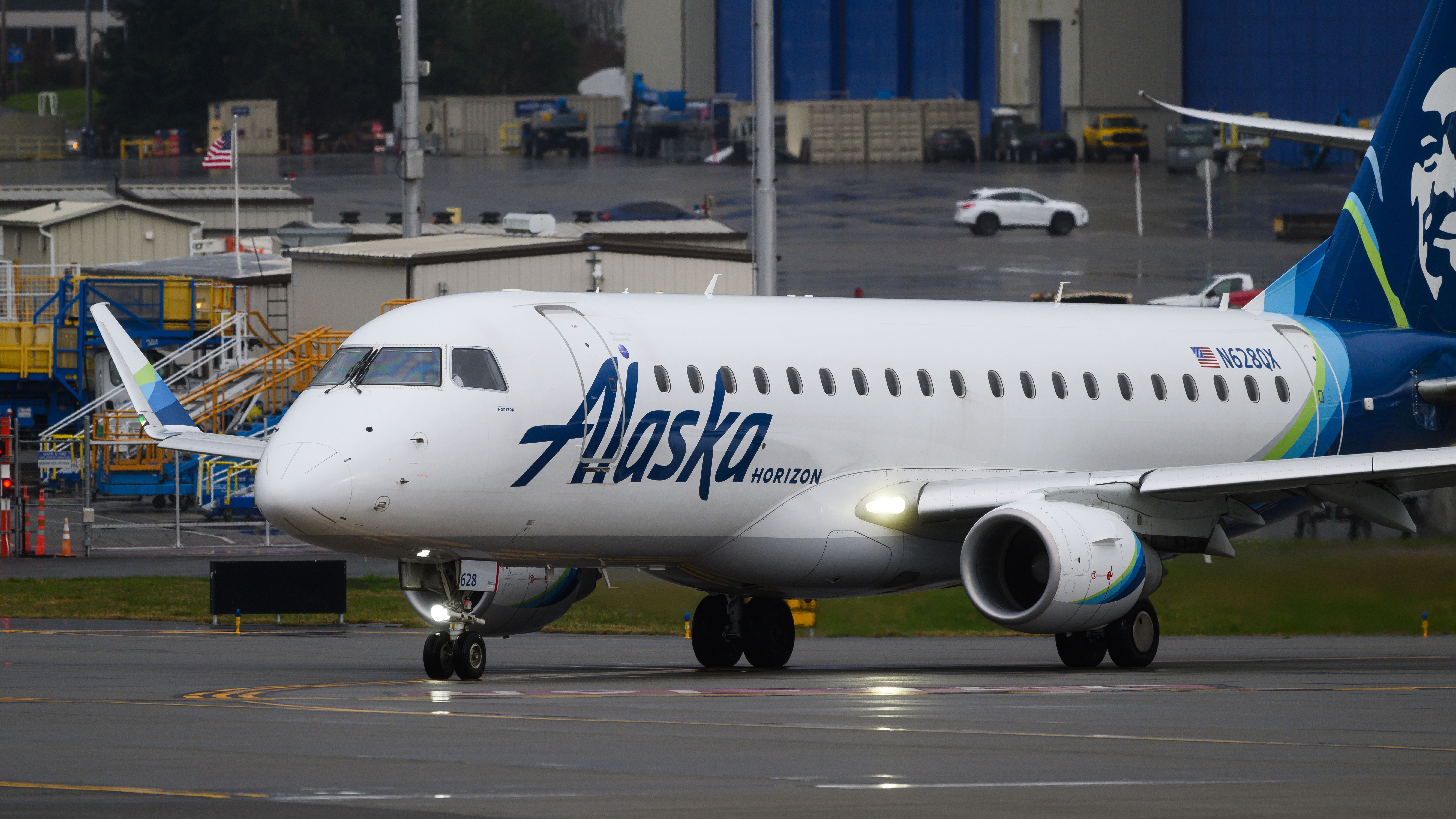 Everett, WA, USA - February 21, 2024; Alaska Airlines Horizon Air Embraer ERJ-175 taxiing with lights on in closeup