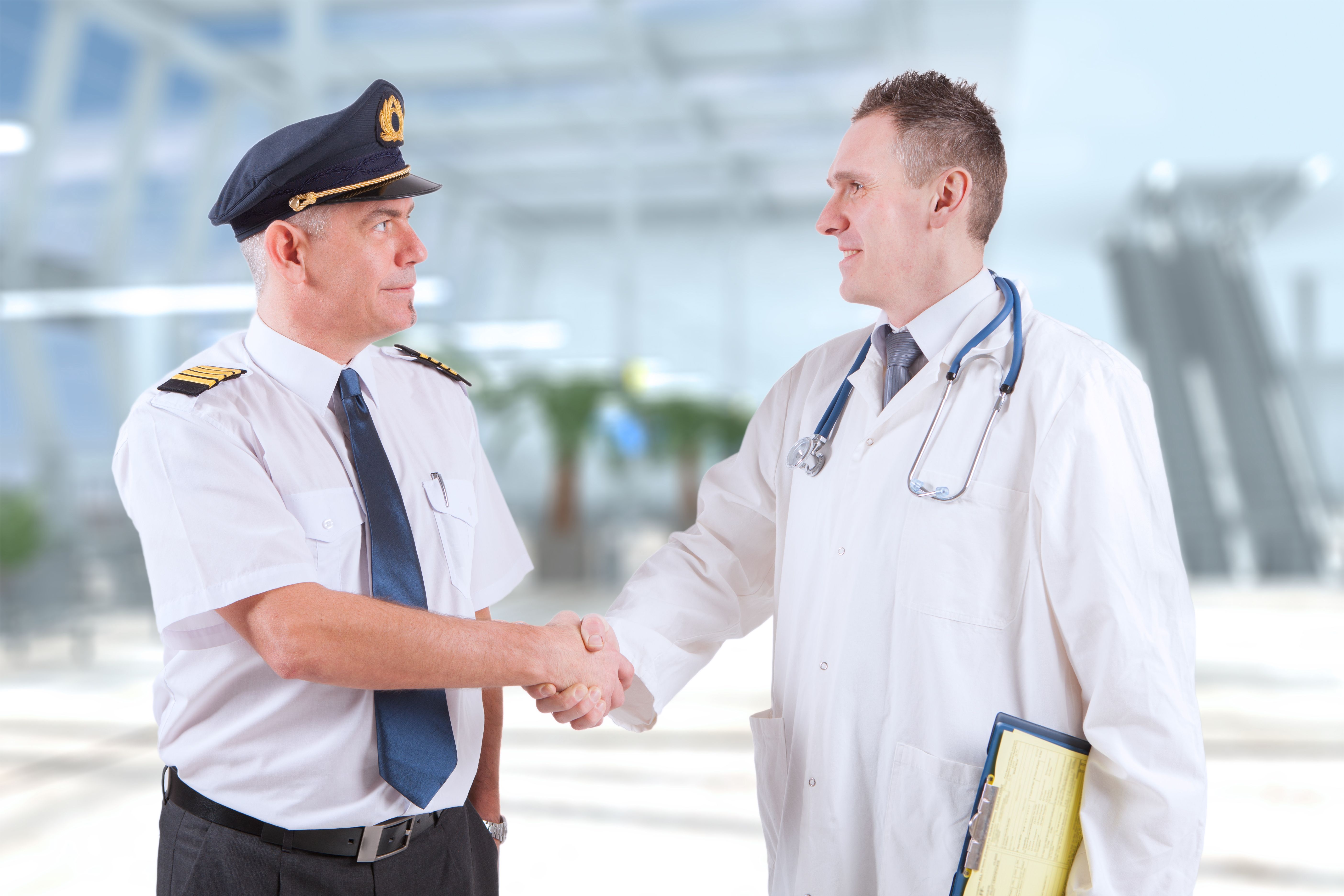 Doctor and a pilot shake hands after handling a medical emergency