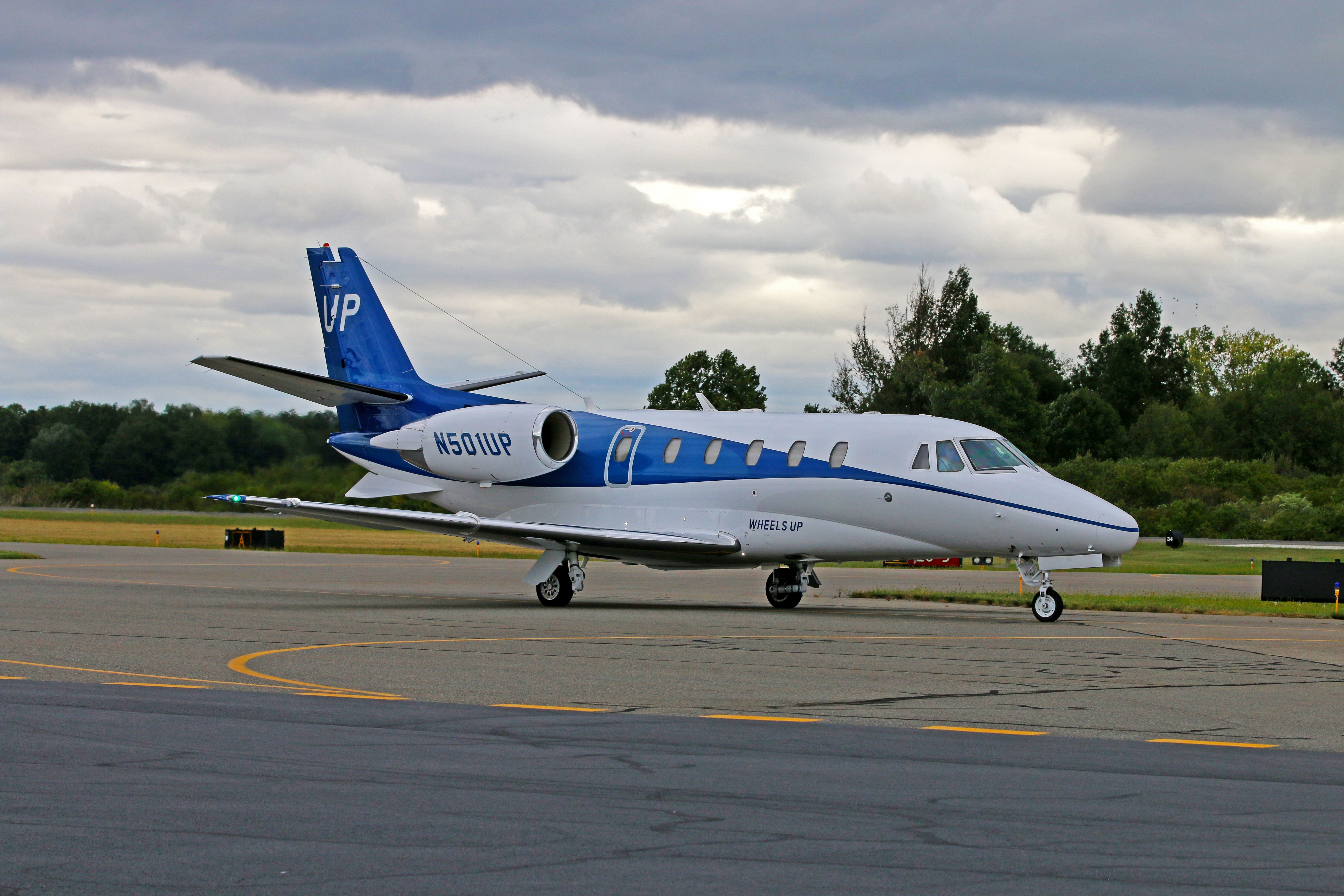 A 2002 Cessna 560XL painted in blue and white of Wheels Up