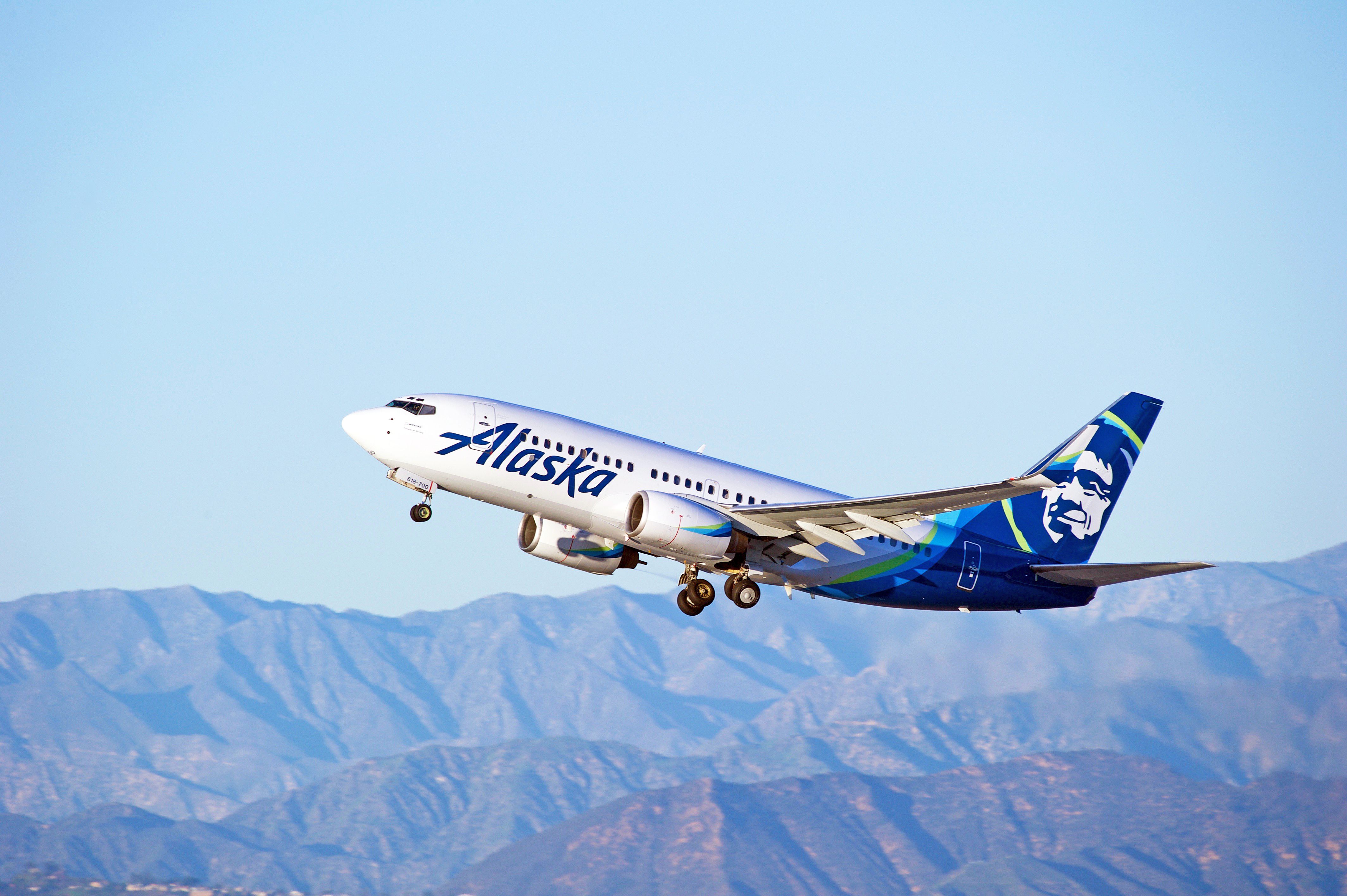 An Alaska Airlines plane in front of mountains