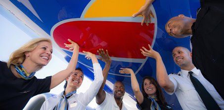 Southwest Airlines crew touching heart under plane