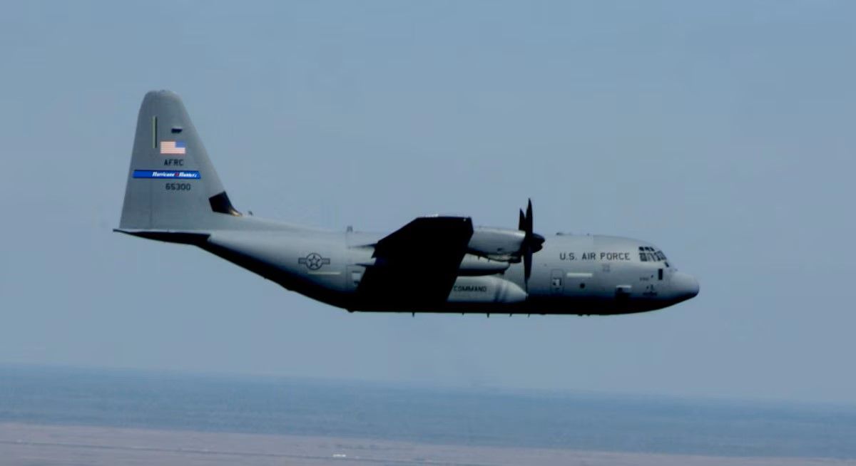 WC-130J Hurricane Hunter Aircraft flies over coastline (jpg)