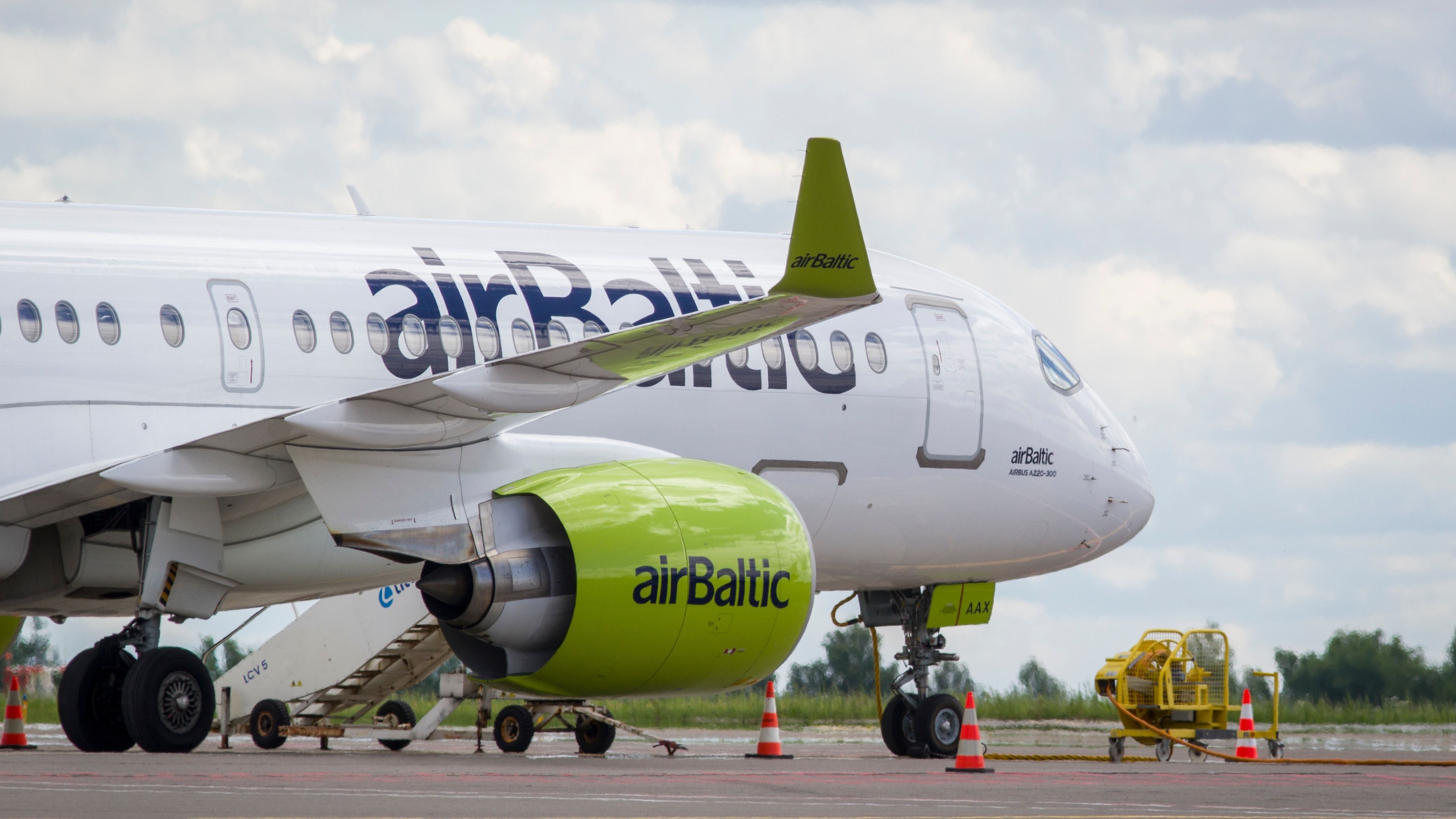 airBaltic Airbus A220-300 parked at Vilnius Airport VNO shutterstock_2214759747