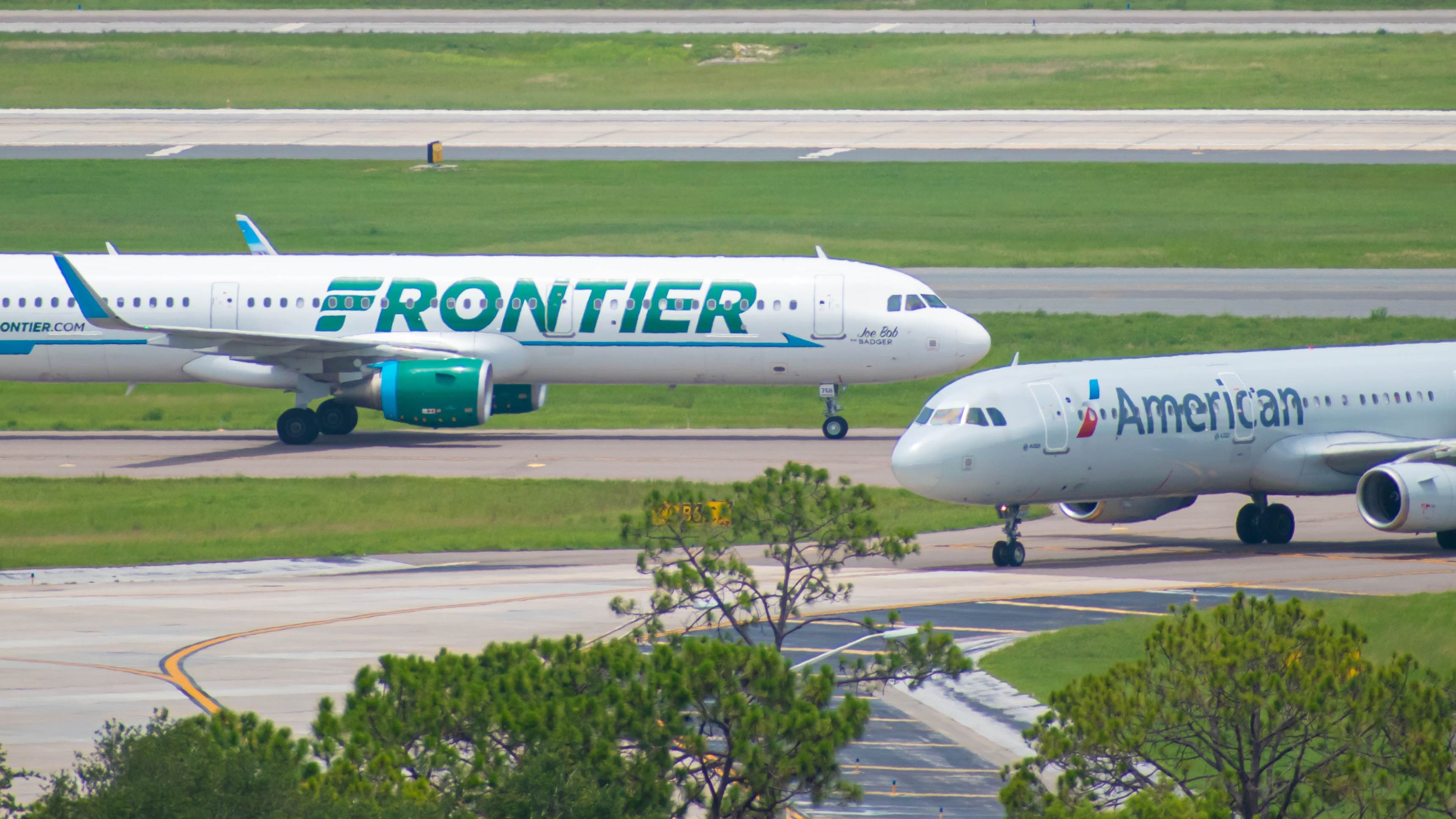 American Airlines and Frontier Airlines aircraft taxiing at ORD shutterstock_1458376070