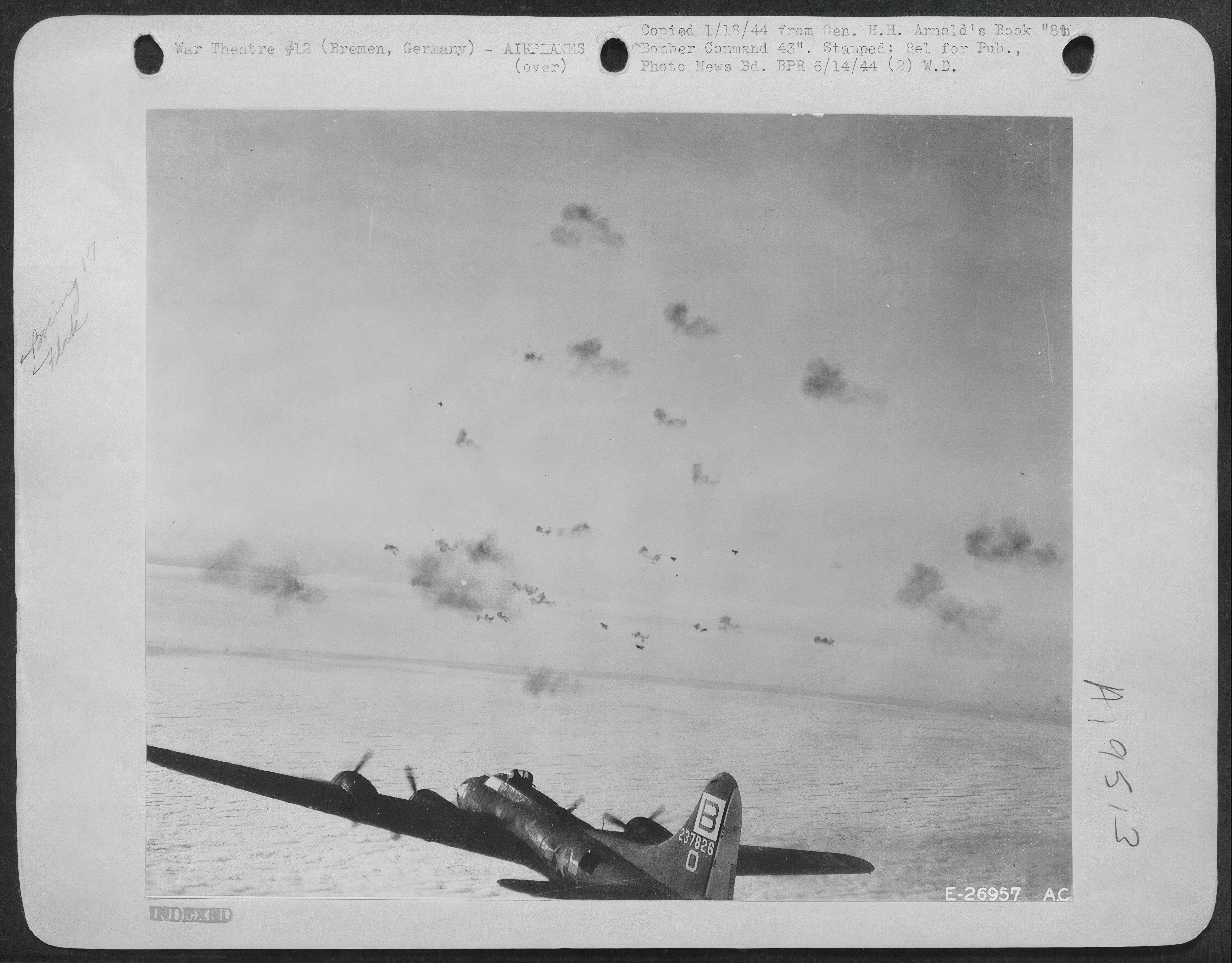 Black and white photo of a B-17 Flying through anti-aircraft fire.
