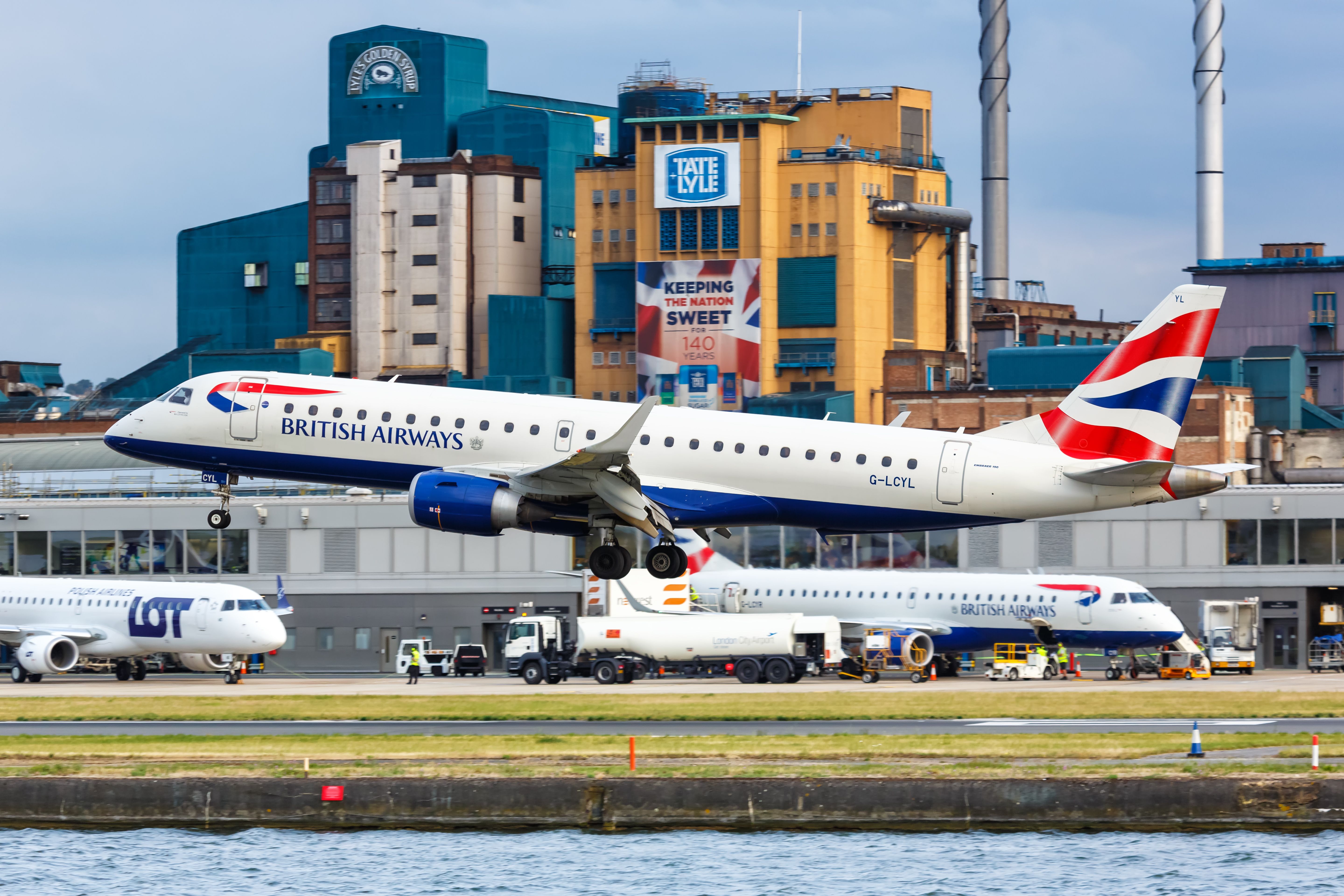 British Airways Embraer E190 landing at London City Airport LCY shutterstock_1483959173