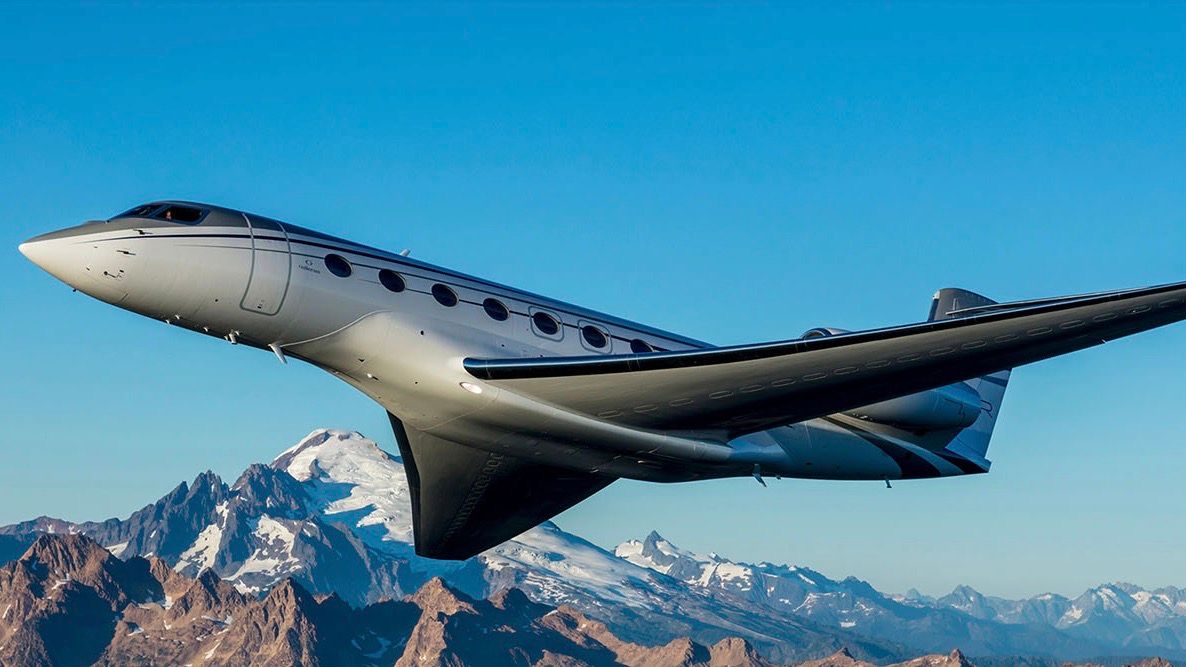 G650ER flying in the sky over mountains